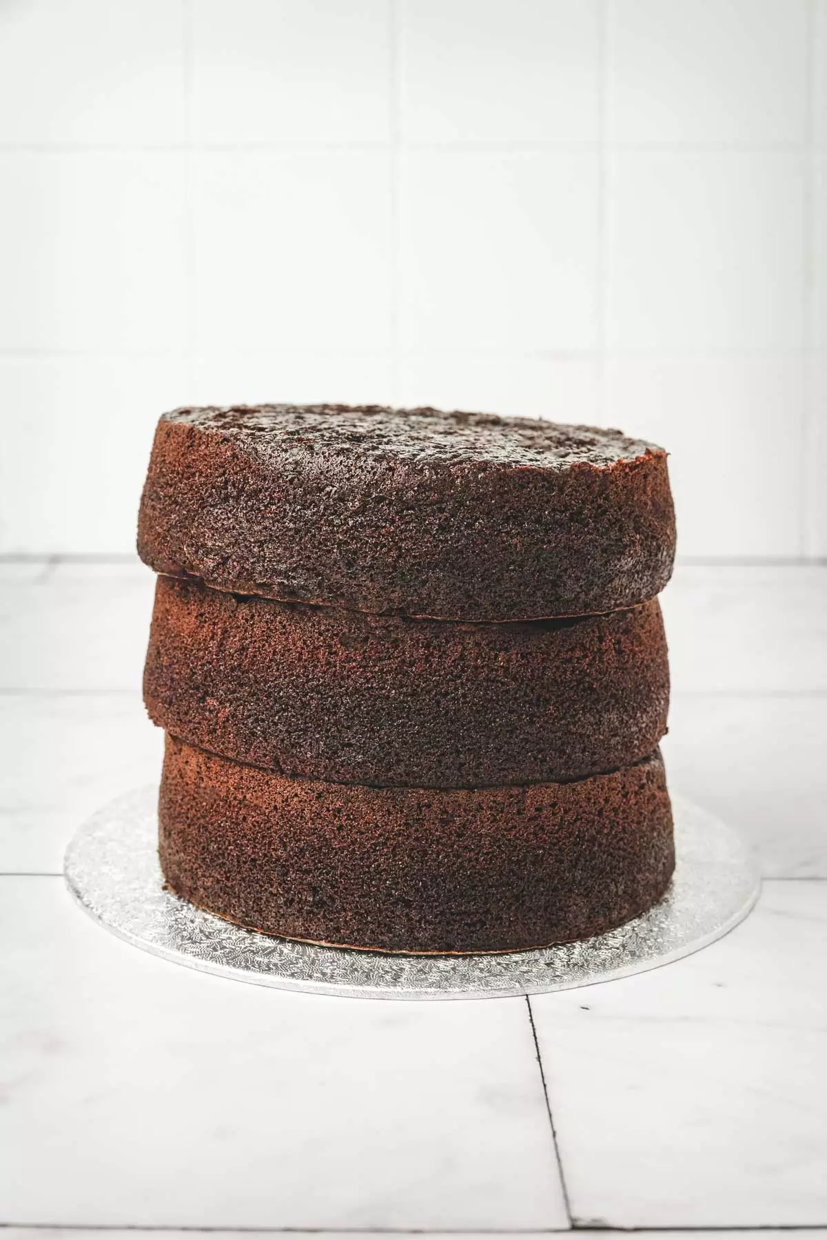 3 layers of chocolate cake on a table