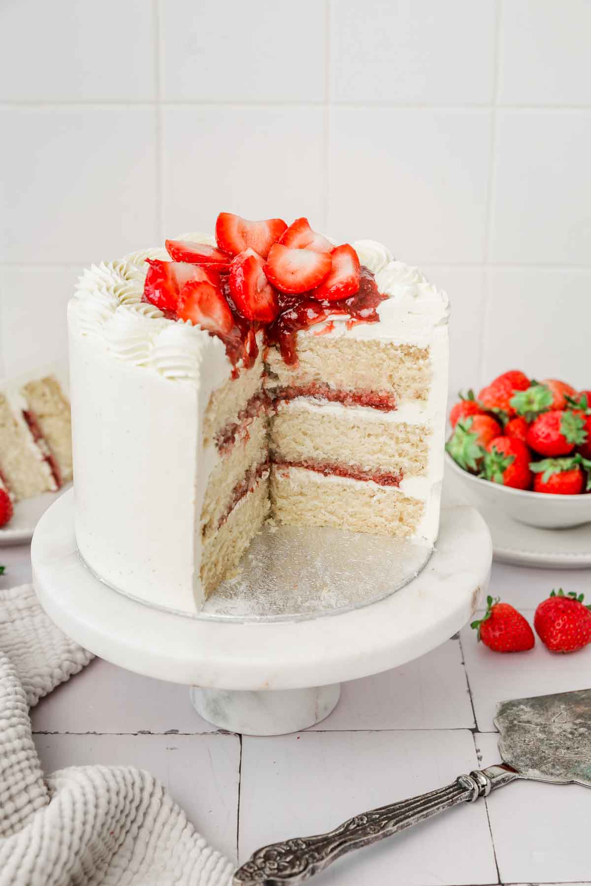 strawberry vanilla cake on a cake stand