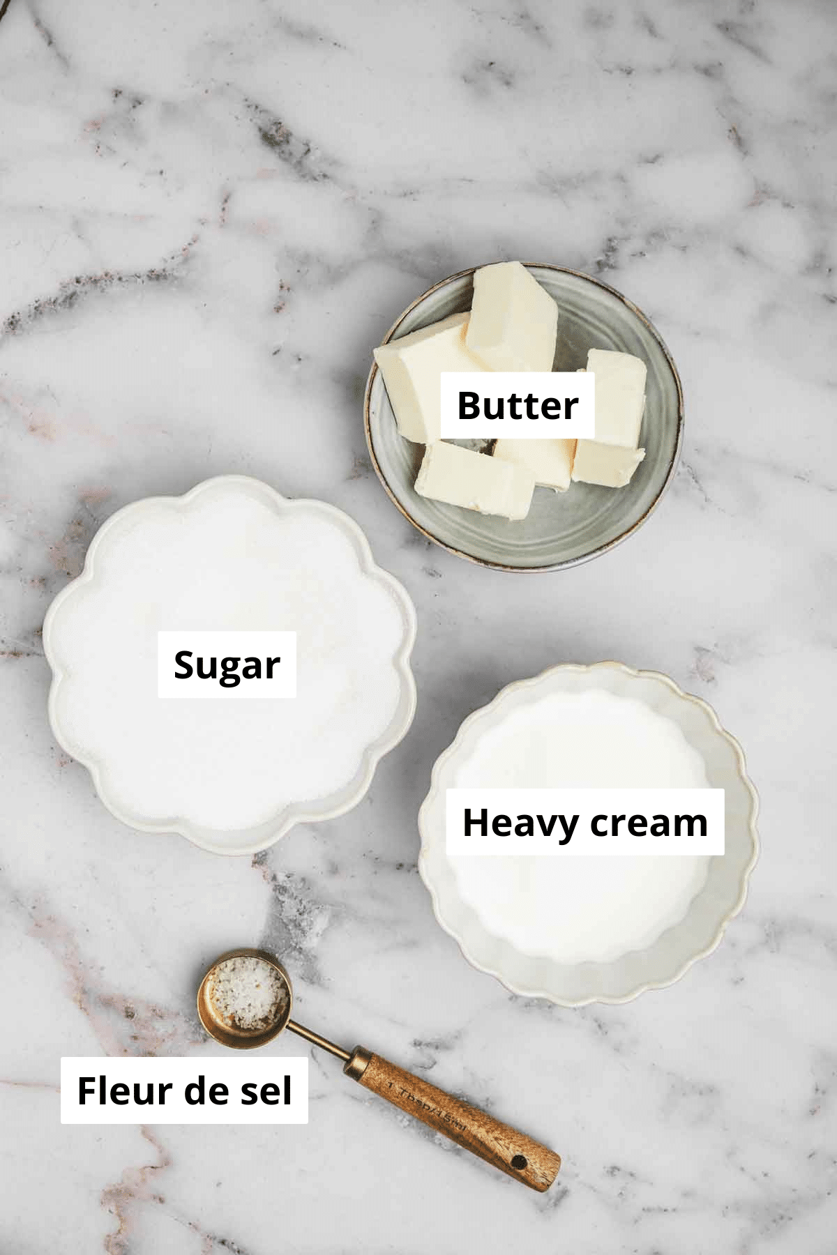 ingredients for salted caramel sauce on a white surface