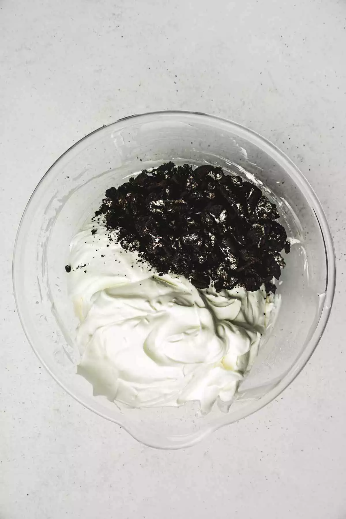 Large bowl with whipped cream and crushed oreo