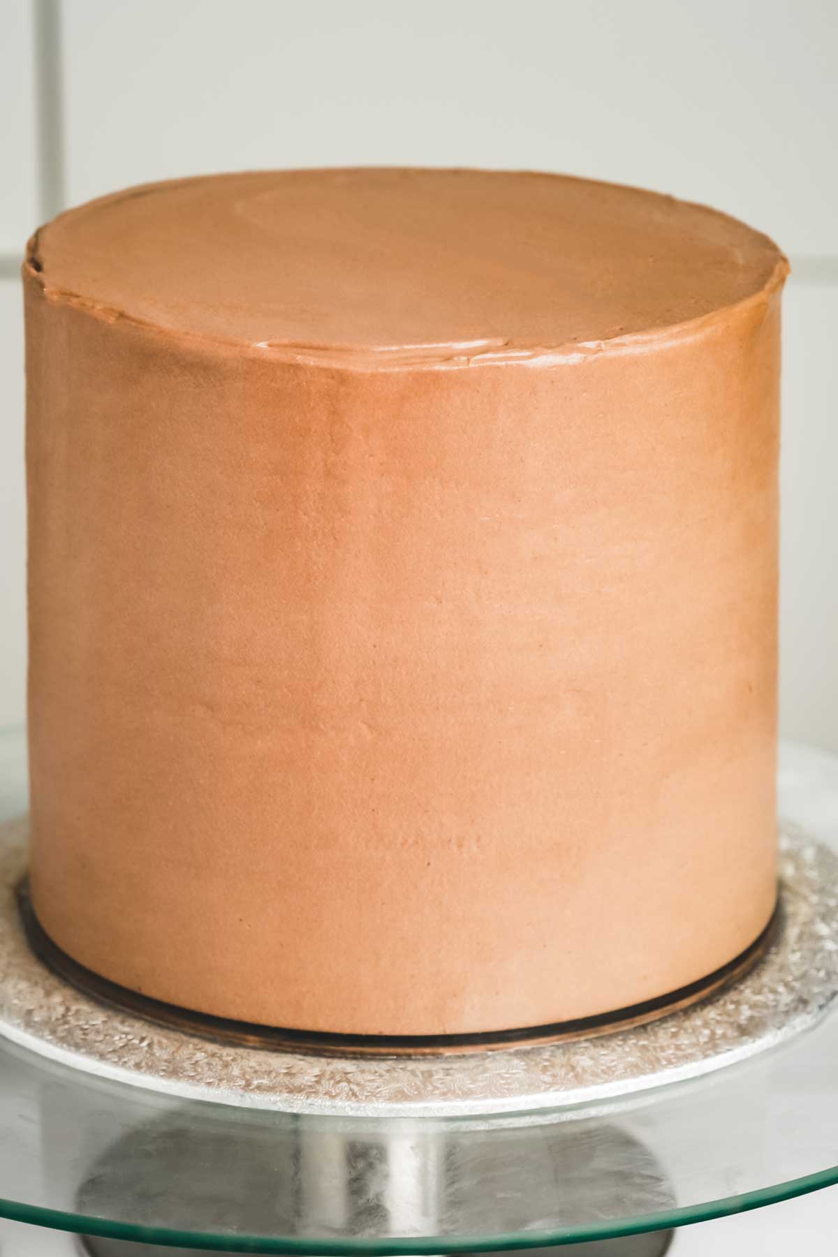 Chocolate cake fully covered with smooth chocolate ganache