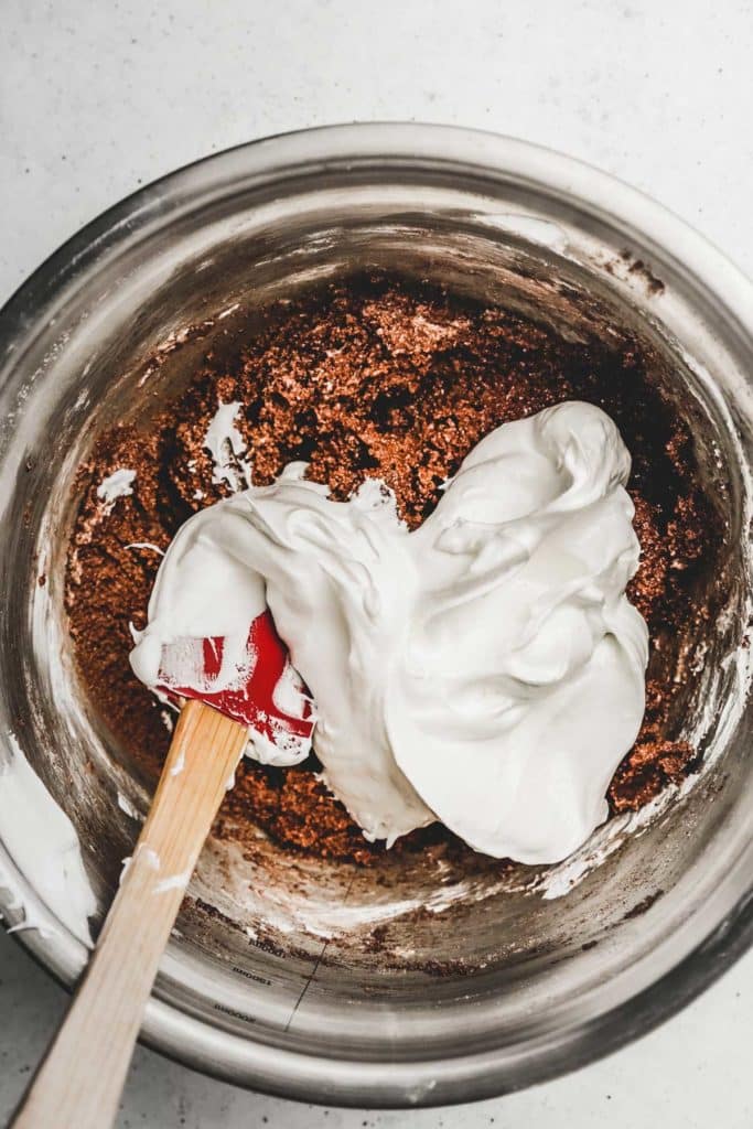 Medium bowl with meringue and chocolate macarons batter