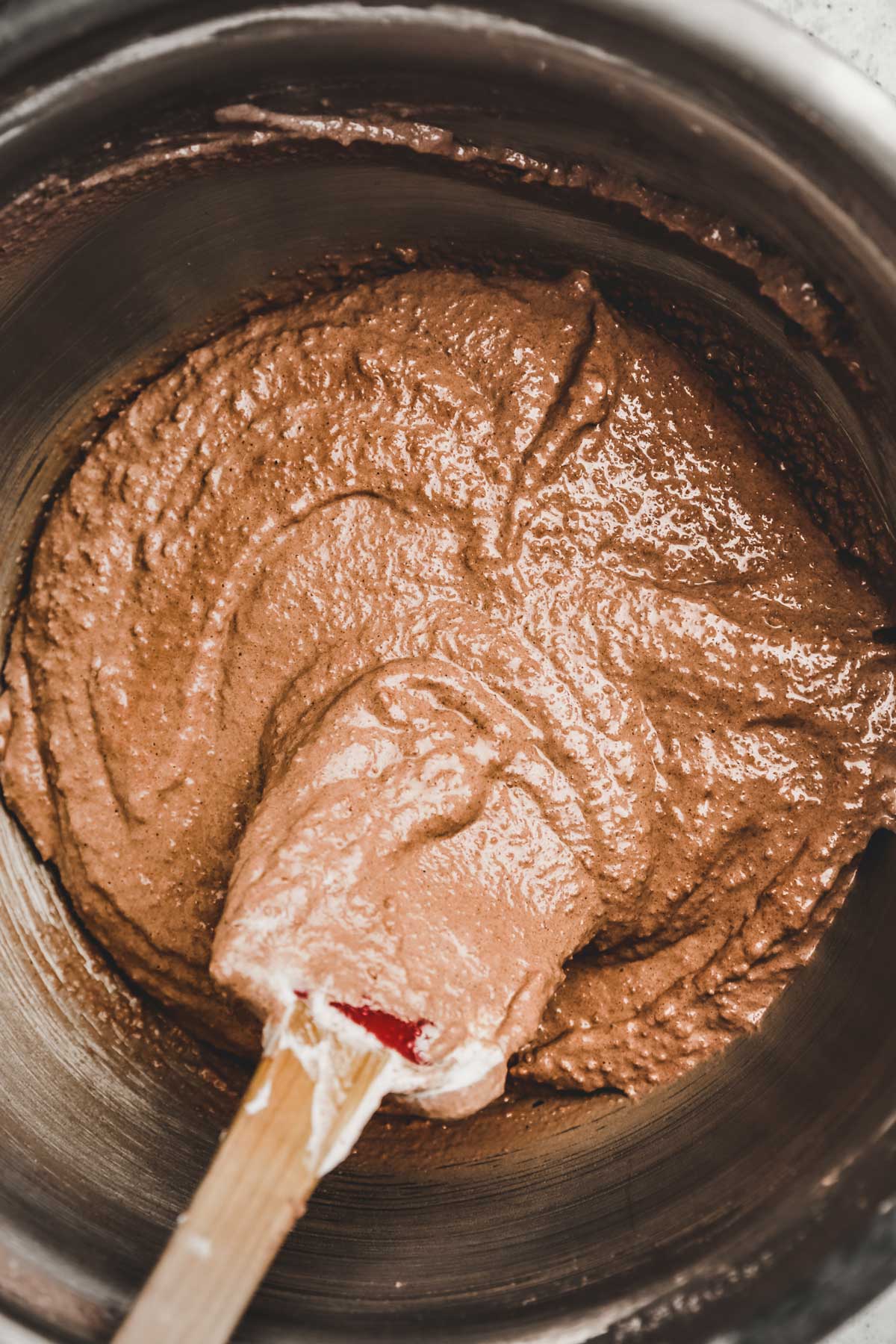 chocolate macaron batter in a mixing bowl