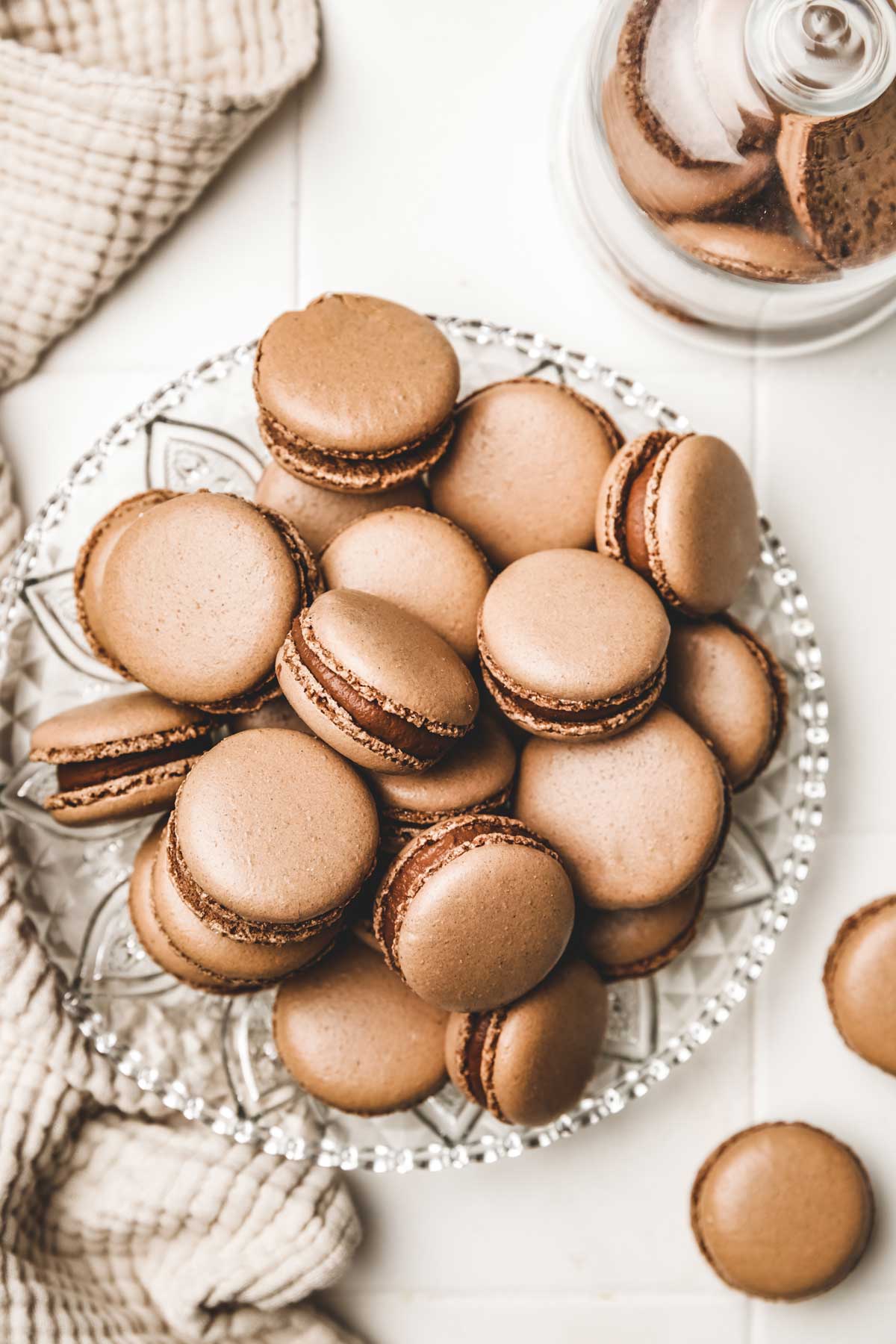 chocolate macarons on a plate with ganache filling