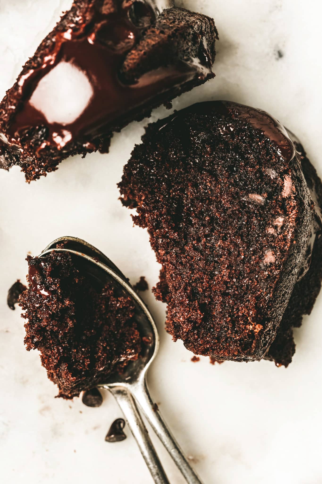 Slice of chocolate bundt cake on a plate with a teaspoon