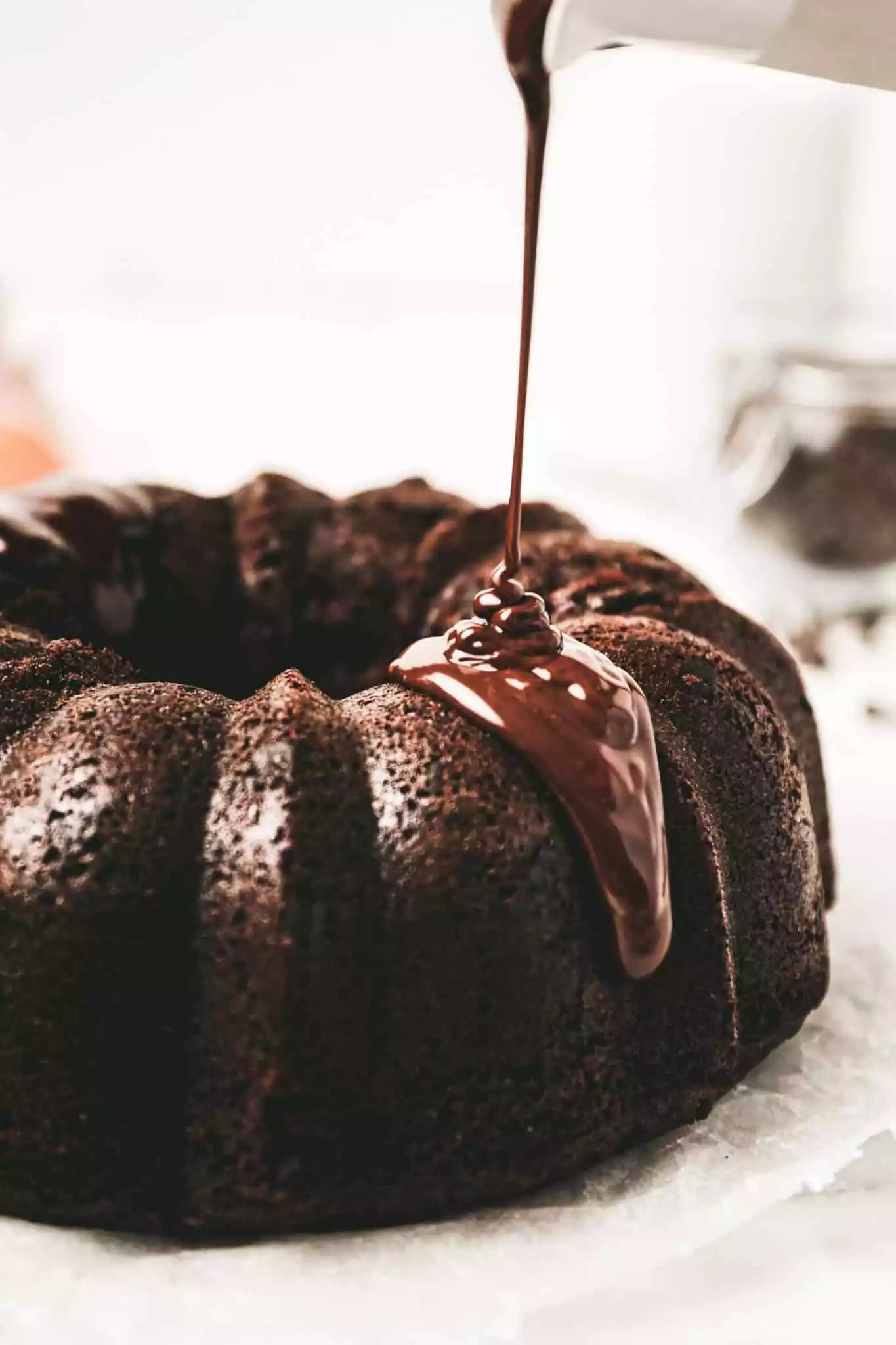 chocolate glaze dripping over a chocolate bundt cake