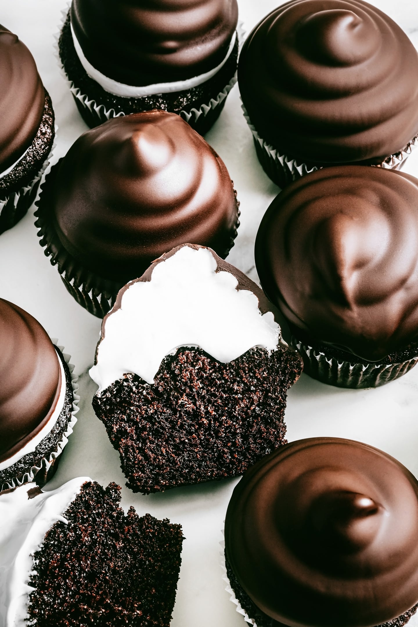high hat cupcakes with meringue topping and chocolate hat