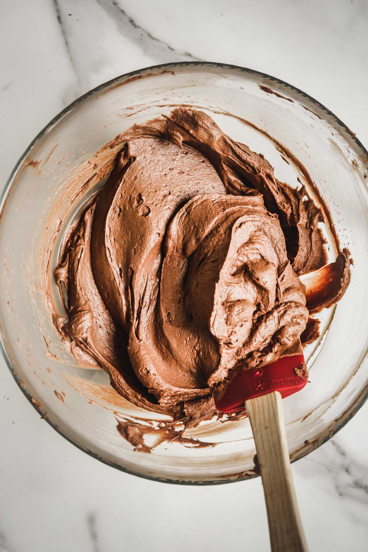 Ganache au chocolat montée dans un bol avec une spatule