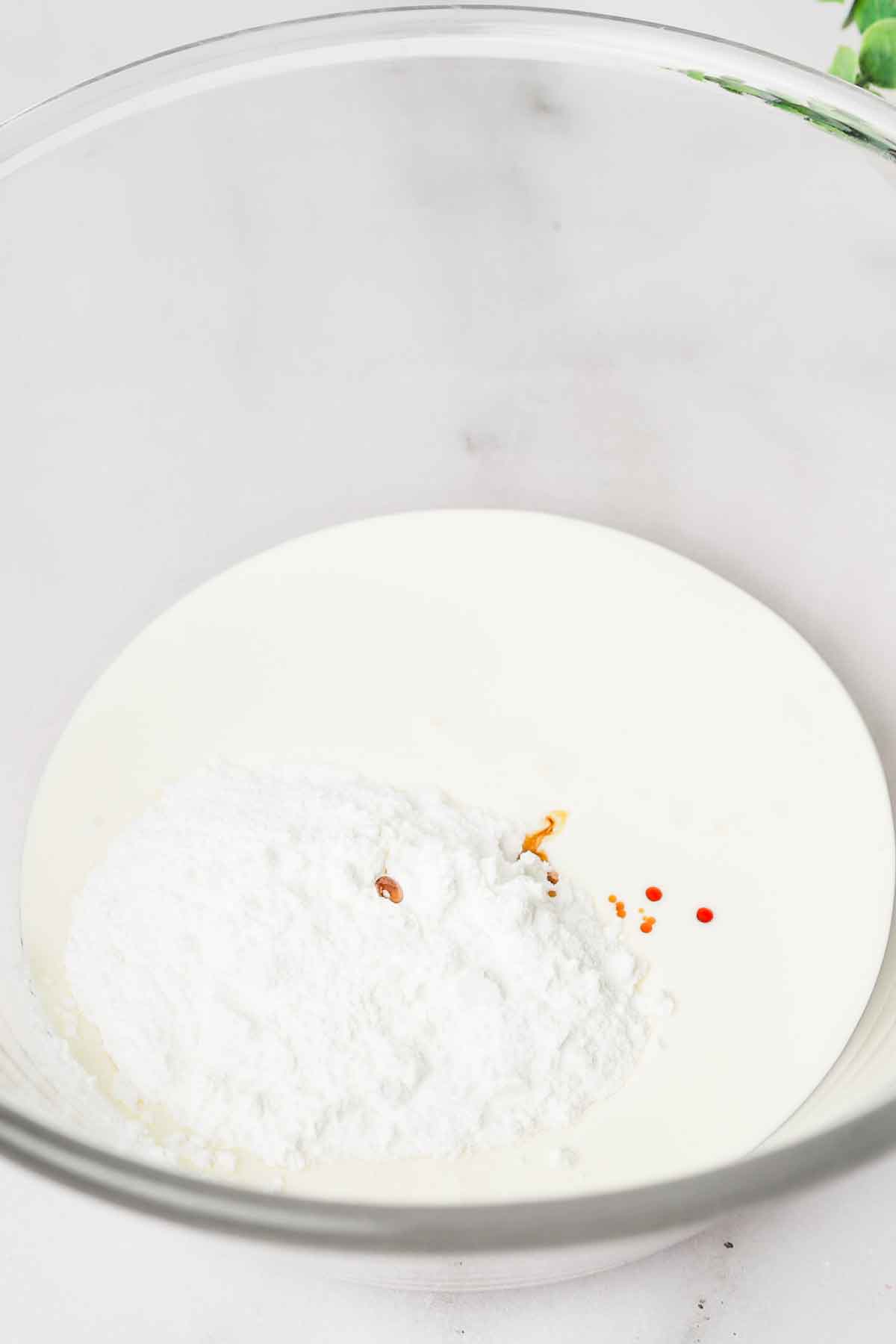 Fresh whipped cream frosting in mixing bowl