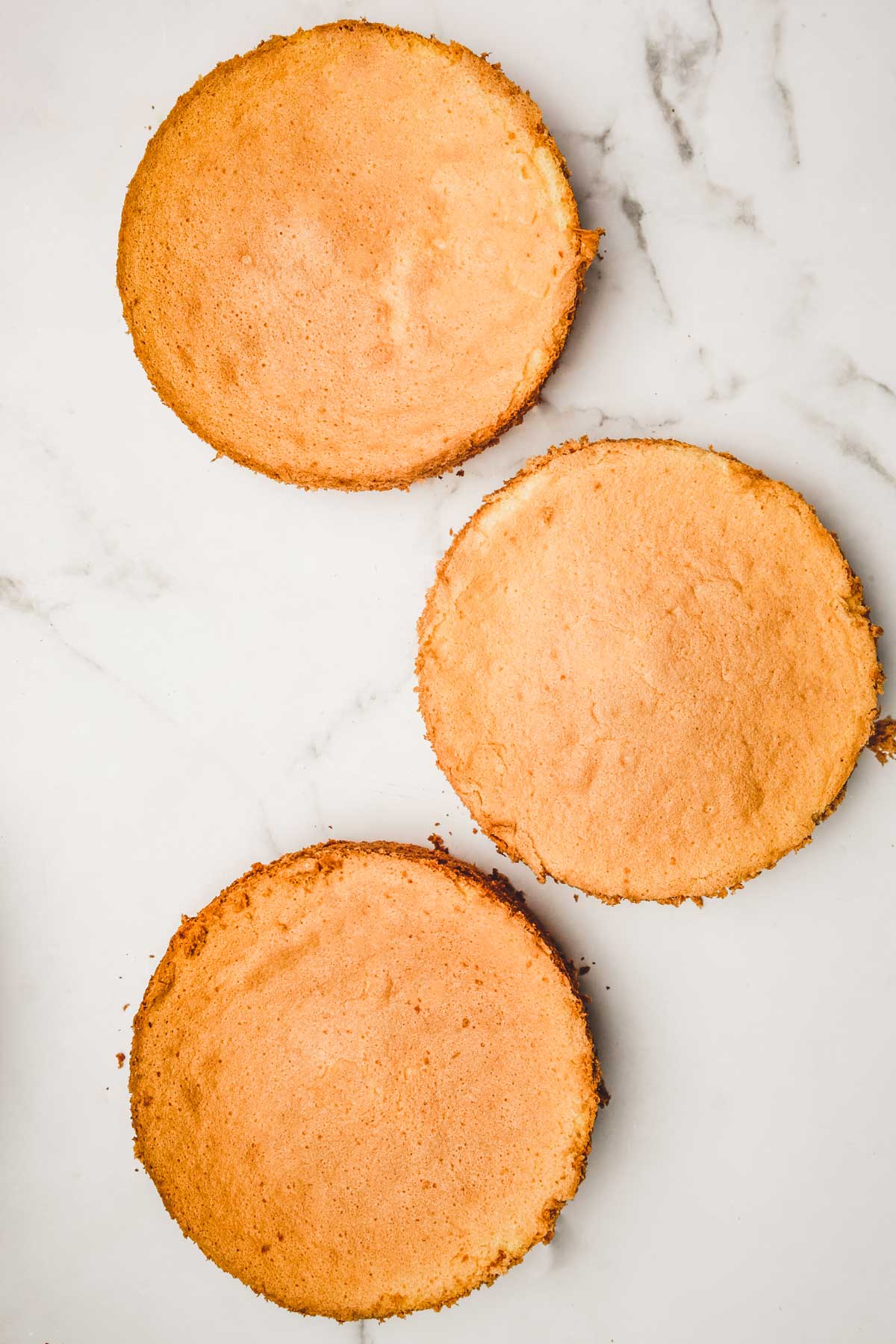 3 chiffon cake sponges on a table after baking