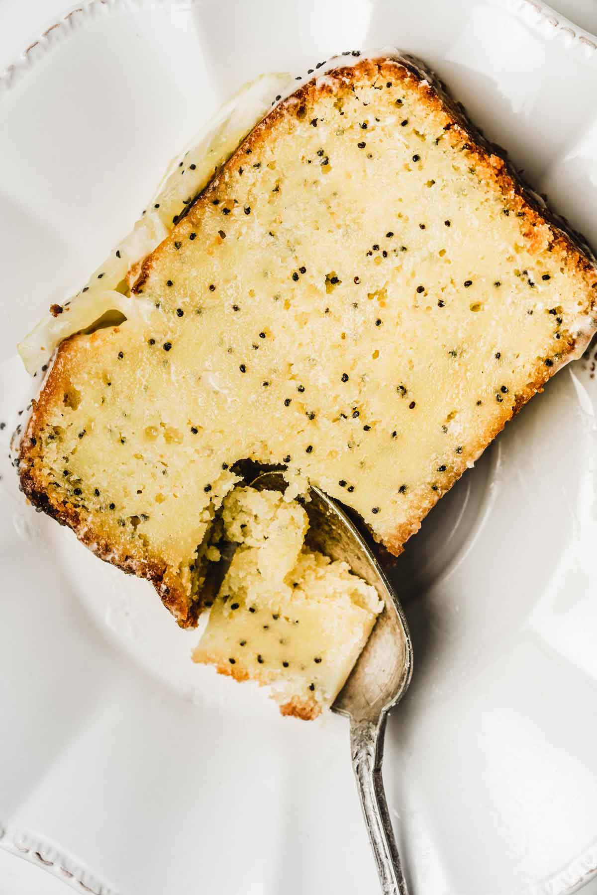 Slice of lemon loaf cake with a spoon