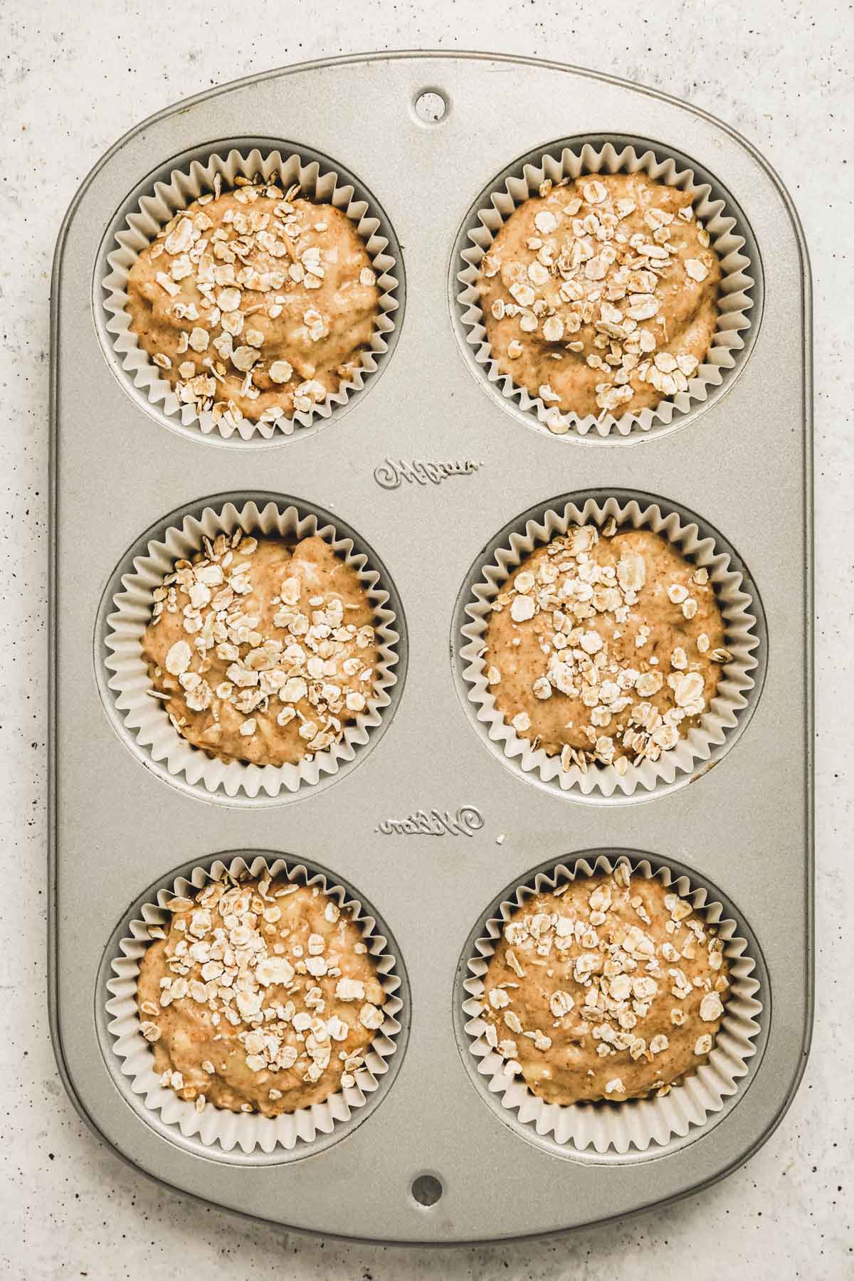 muffins pan with banana oatmeal muffin cake batter