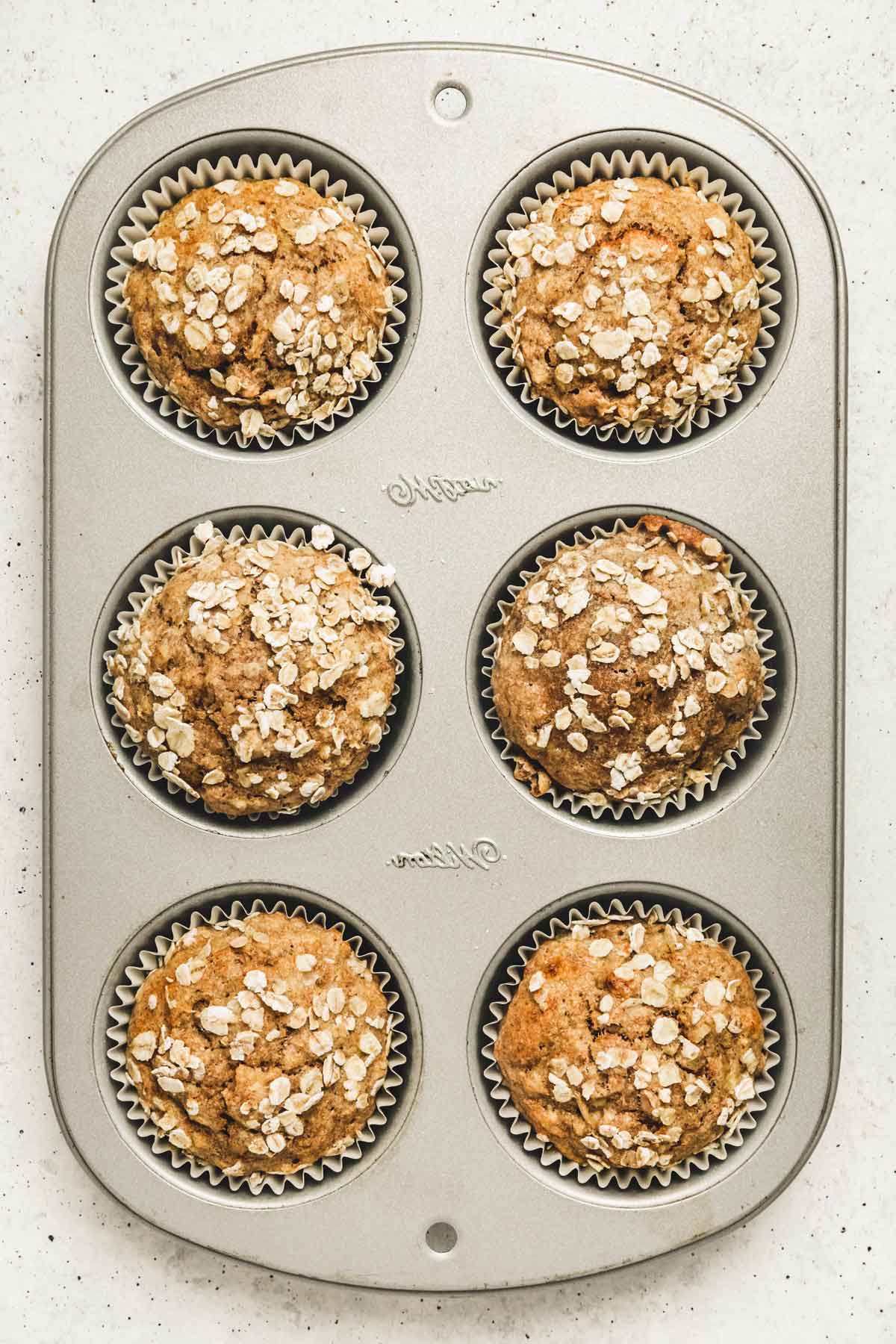 muffin pan with baked banana muffins