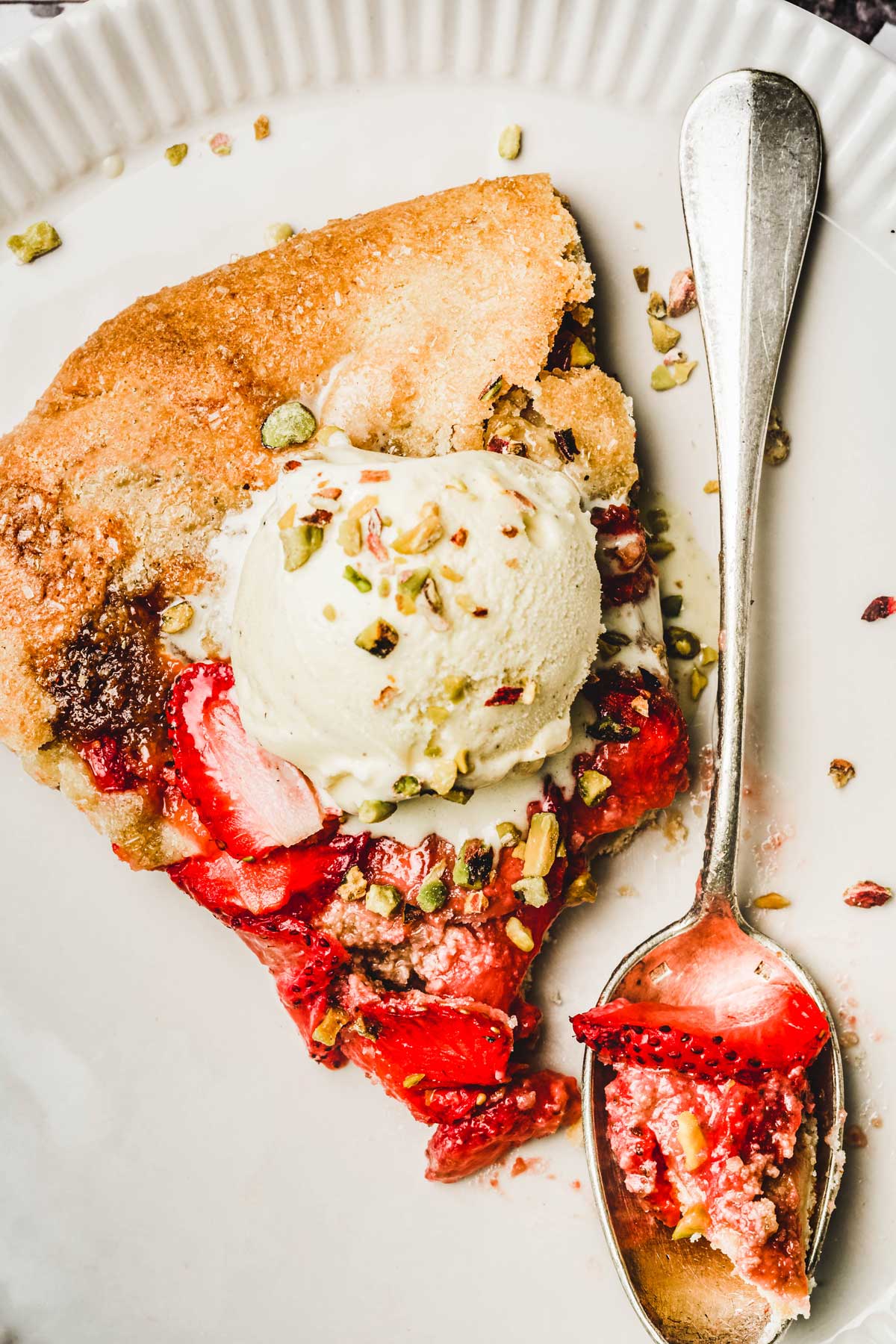 Rustic strawberry tart with ice cream on a plate