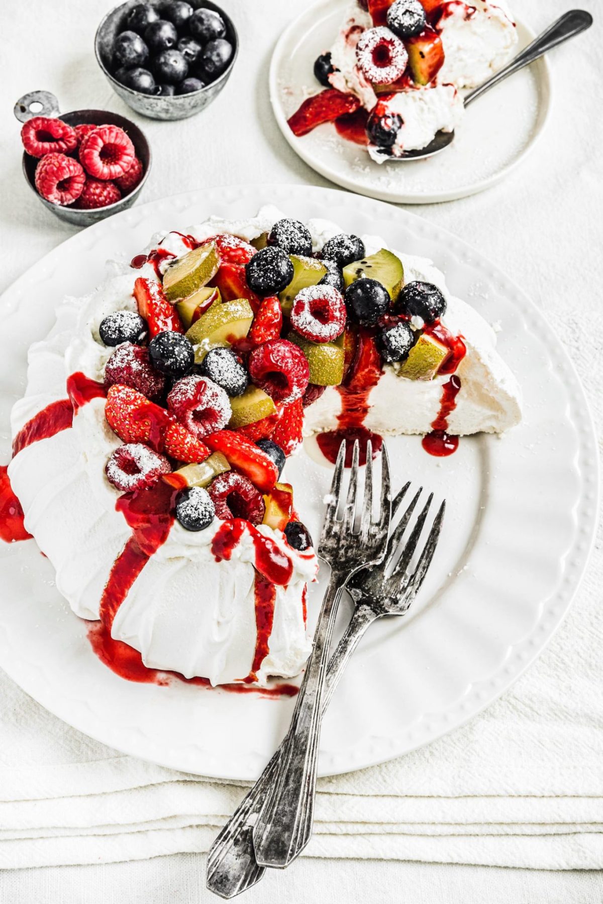 pavlova recipe sliced on a table with crisp shell and soft center