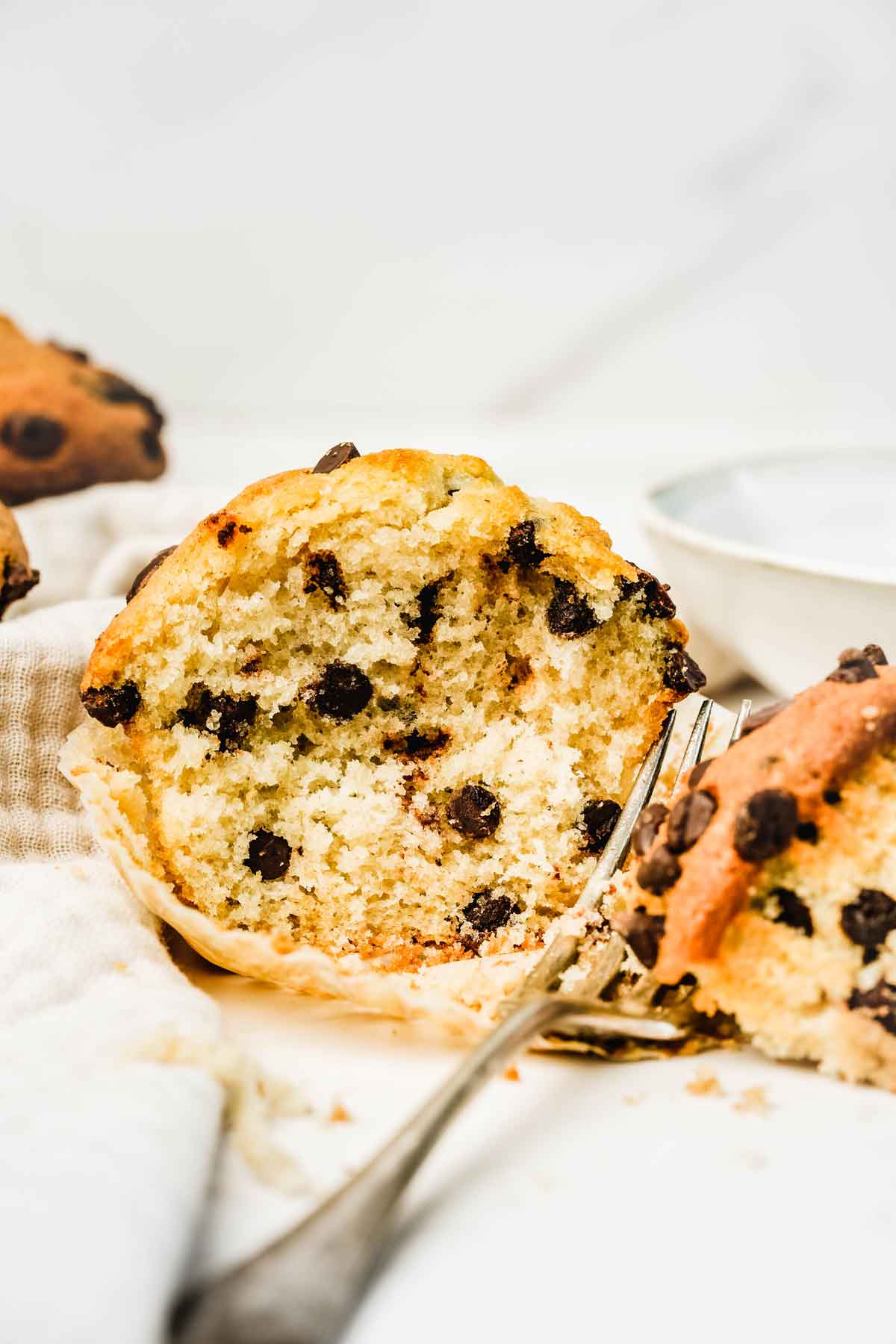 Chocolate chip muffin cut with a fork