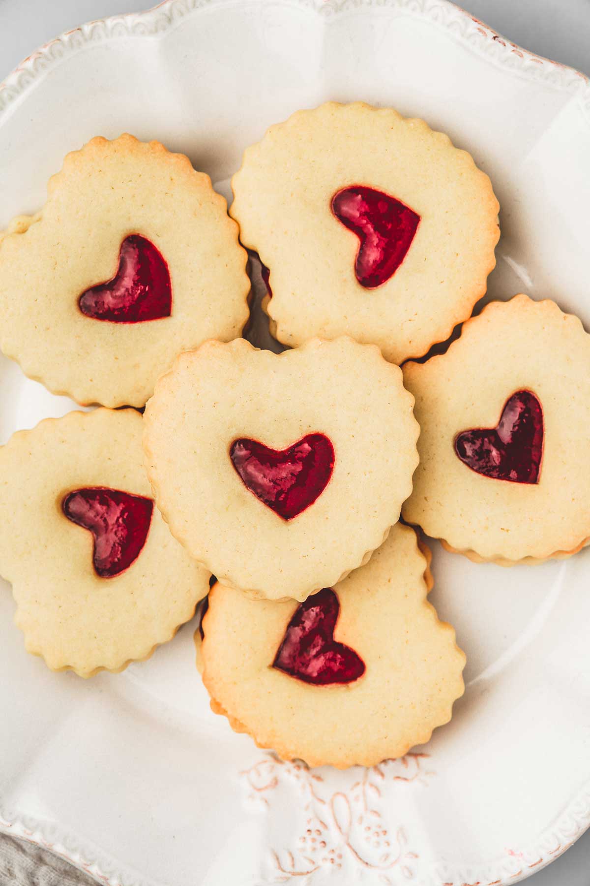 shortbread linzer cookie filled with jam on a plate