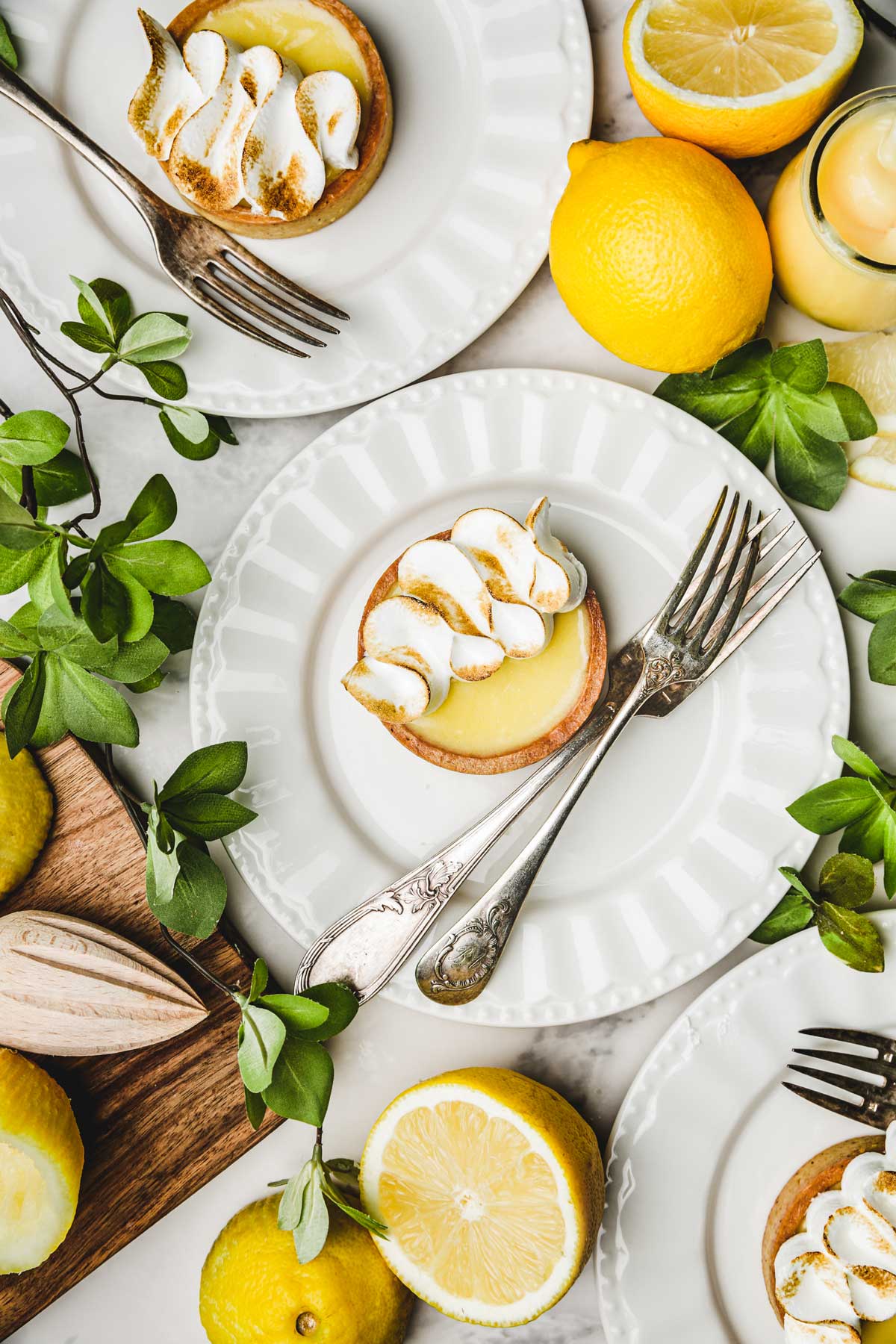 mini lemon meringue tarts on a dessert plate