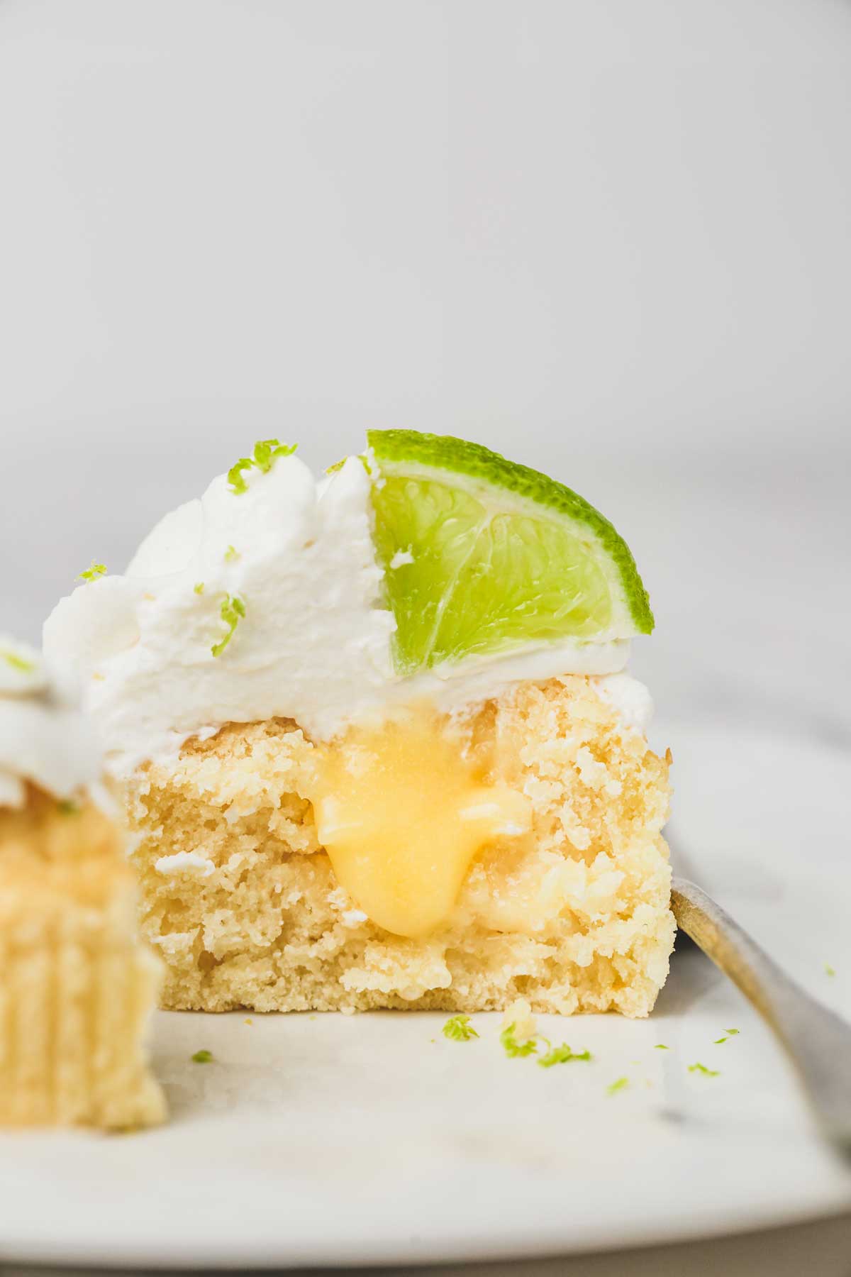 lemon cupcake cut in half with a heart of lemon curd