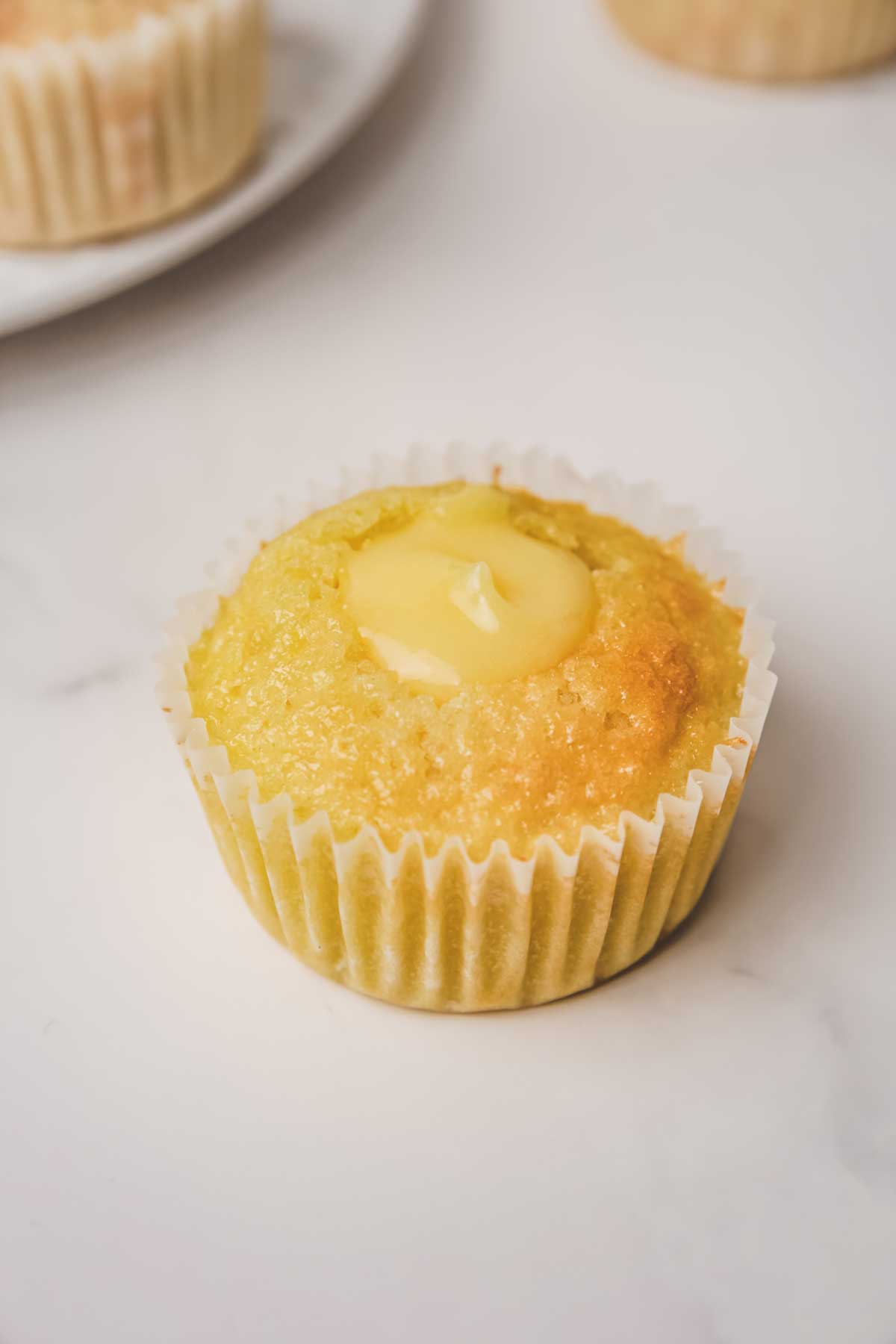 lemon curd filled cupcakes on a tabe