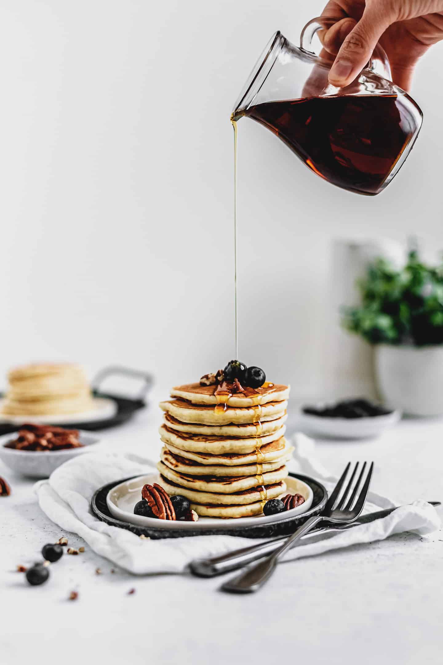 fluffy pancakes on a plate with maple syrup