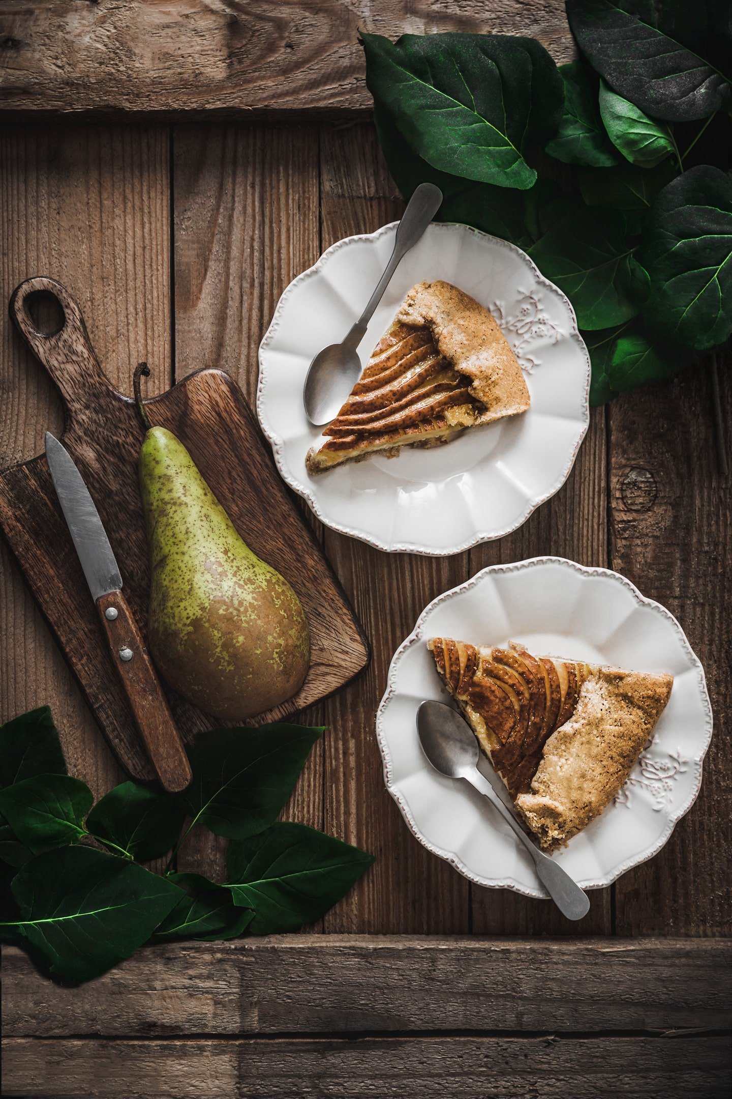 wood table with sliced pear tart