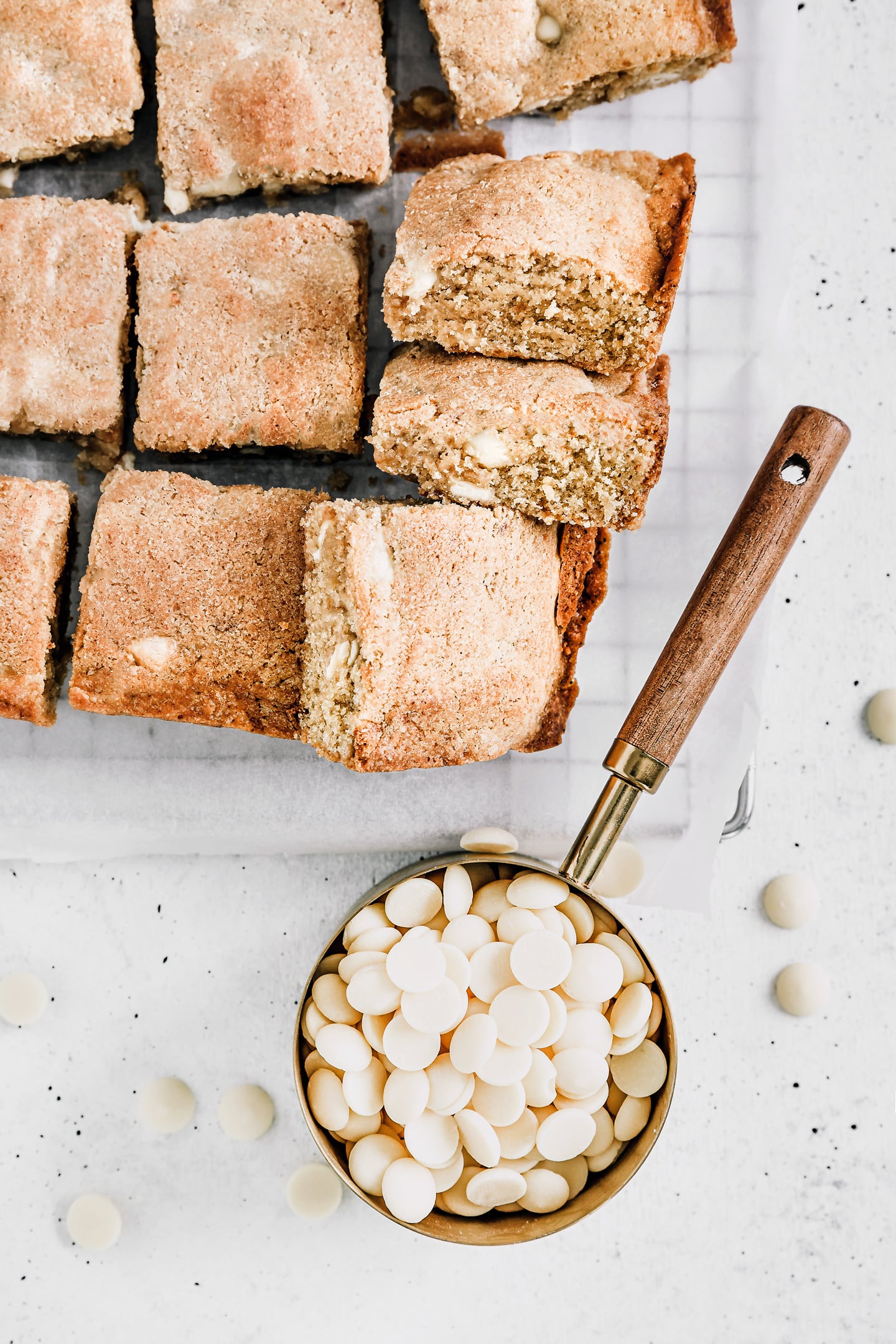 White chocolate chips blondies sliced on a wire rack