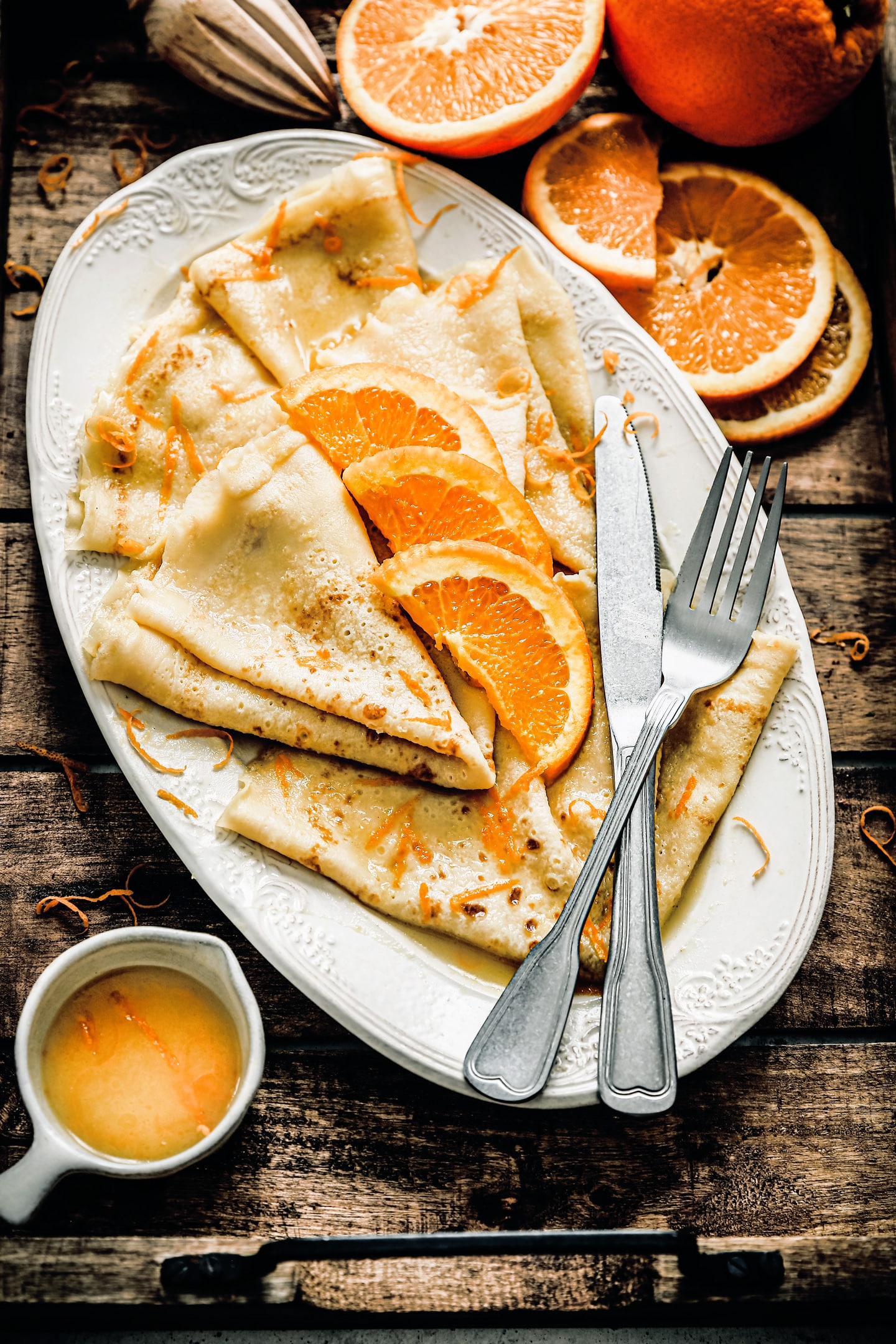 crepes suzette with fresh orange juice sauce and citrus zest