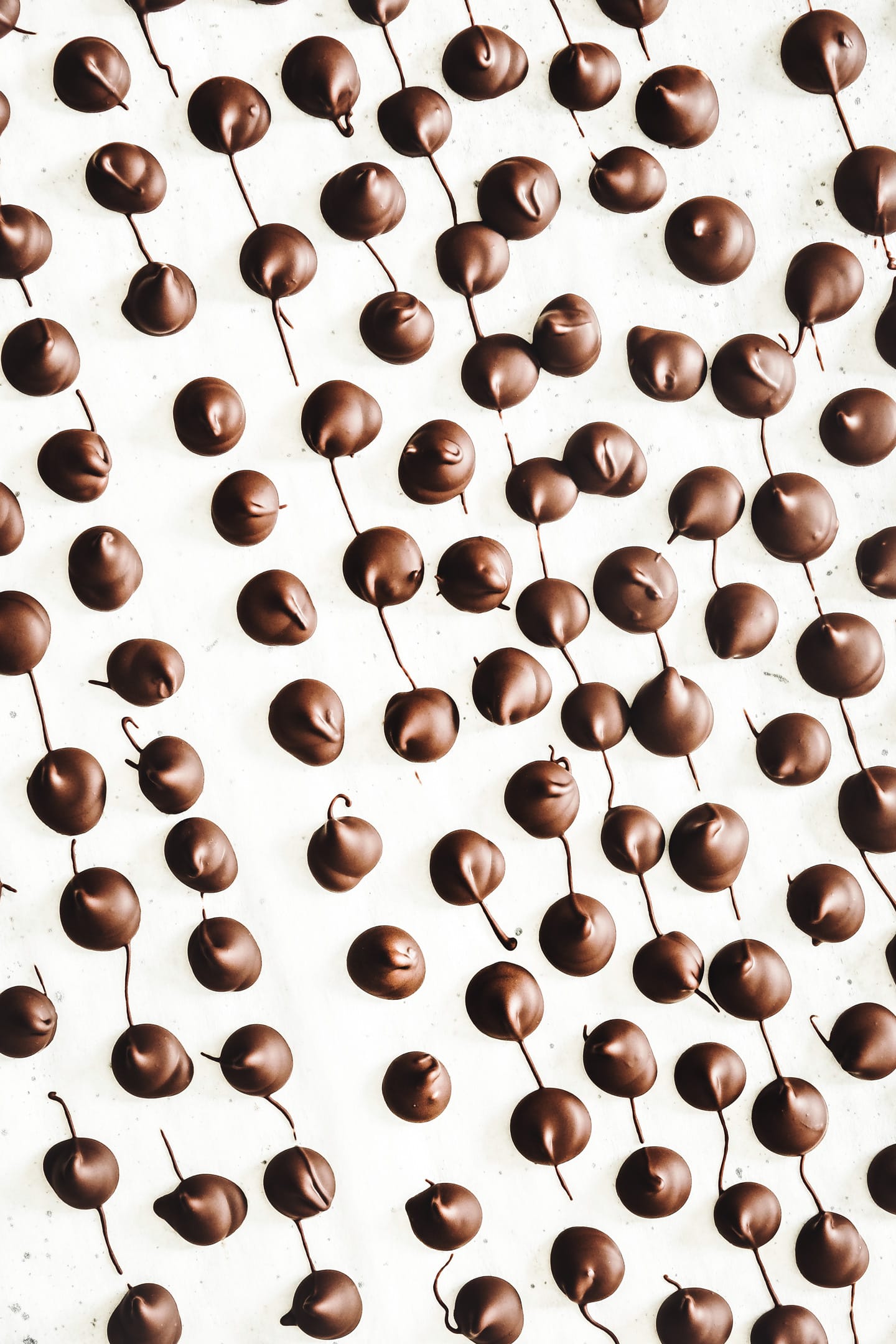 hardened homemade chocolate chips on parchment