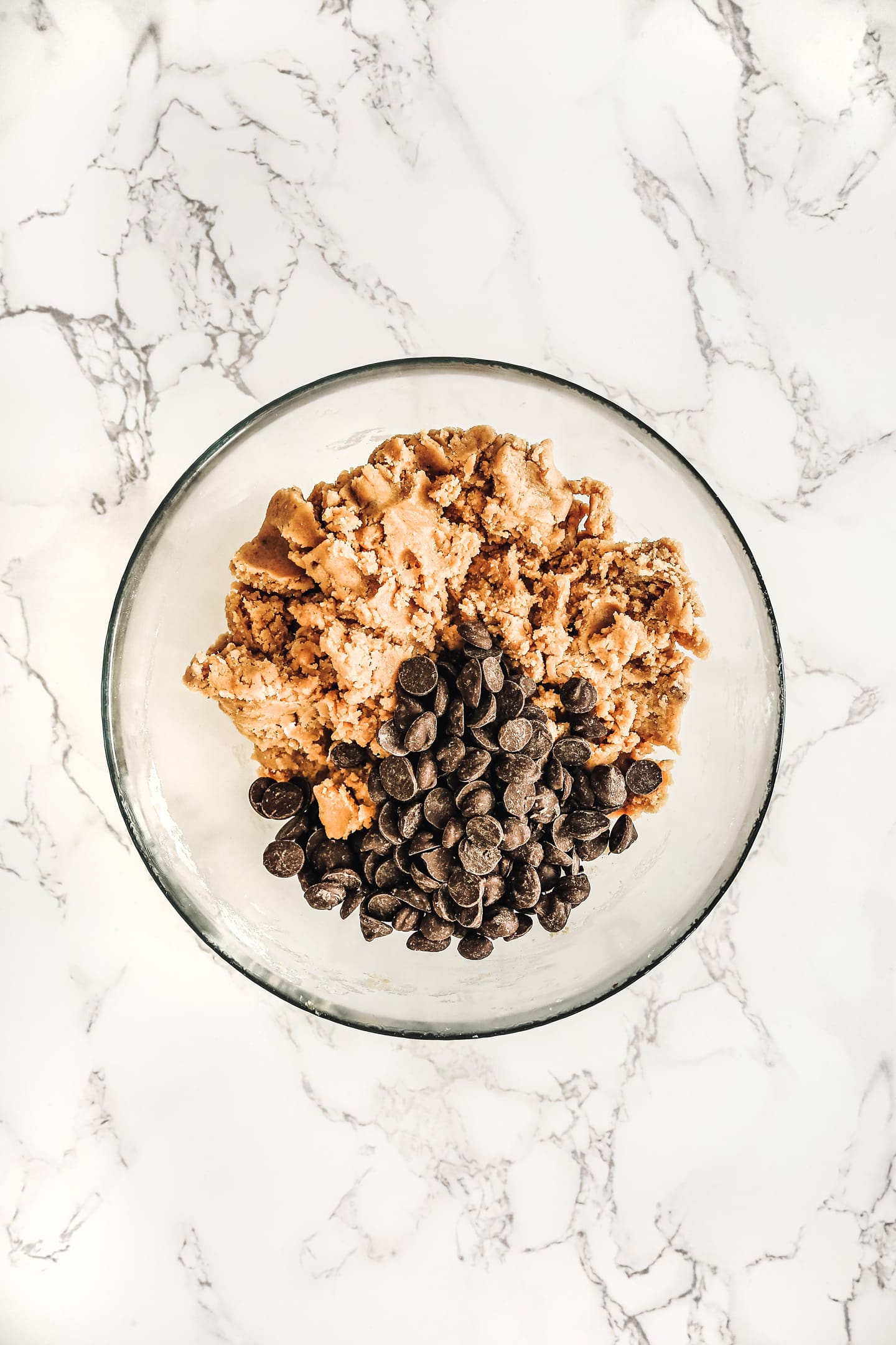 Medium bowl with cookies batter with chocolate chips