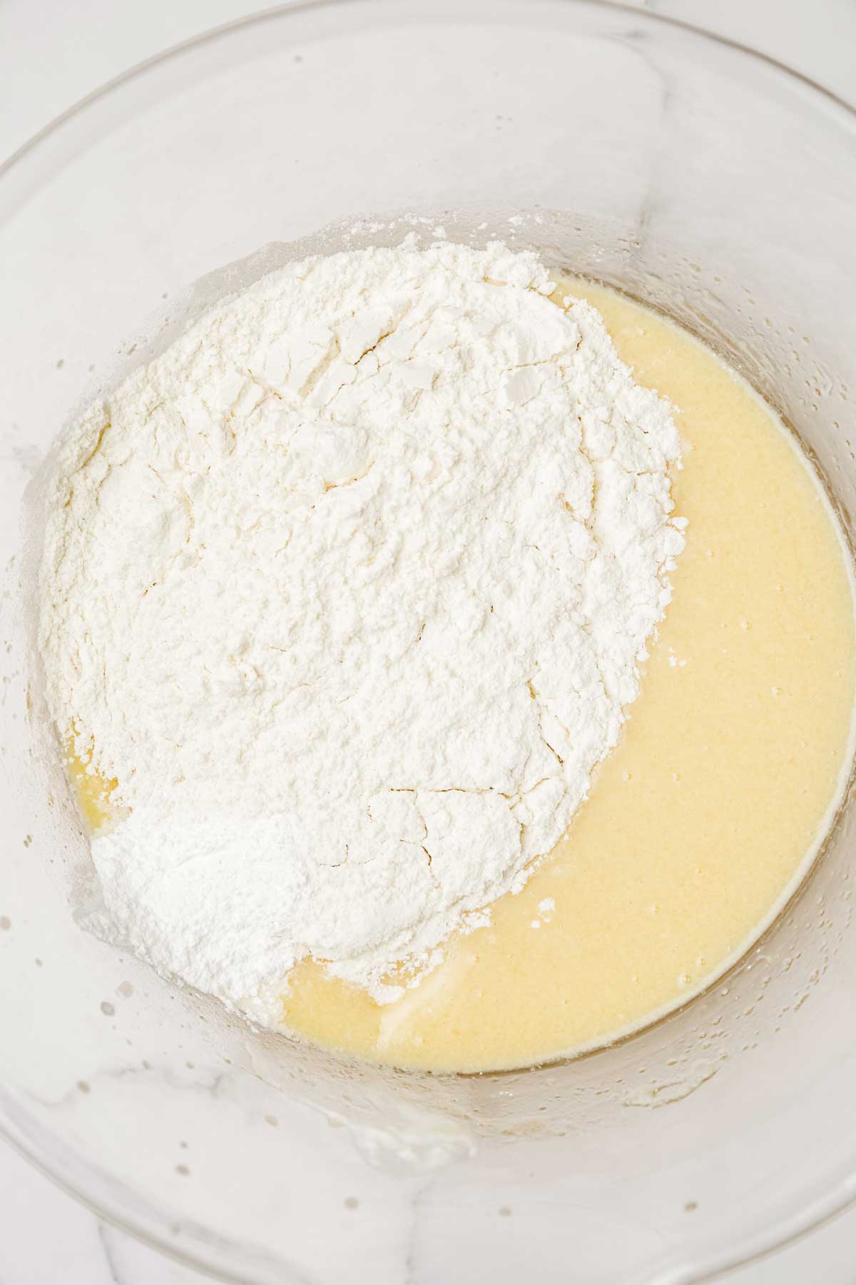 Bowl with cake batter and flour for French apple cake