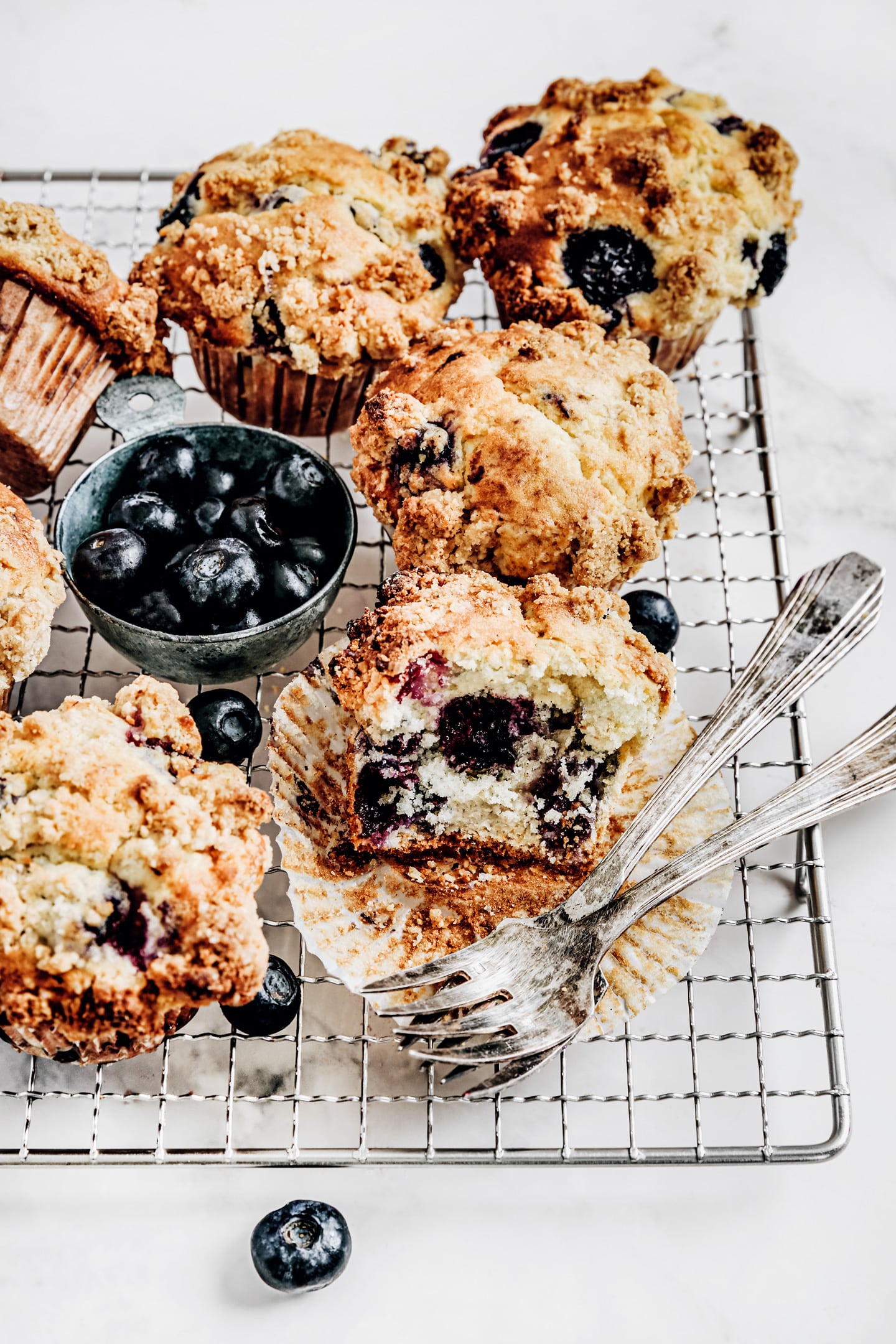 Lemon blueberry muffins recipe with streusel topping blueberry muffins on a cake rack