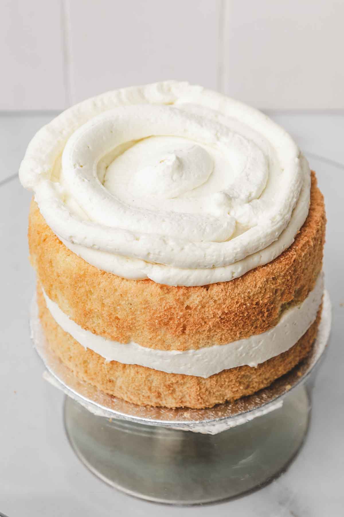 vanilla cake layer on a cake stand