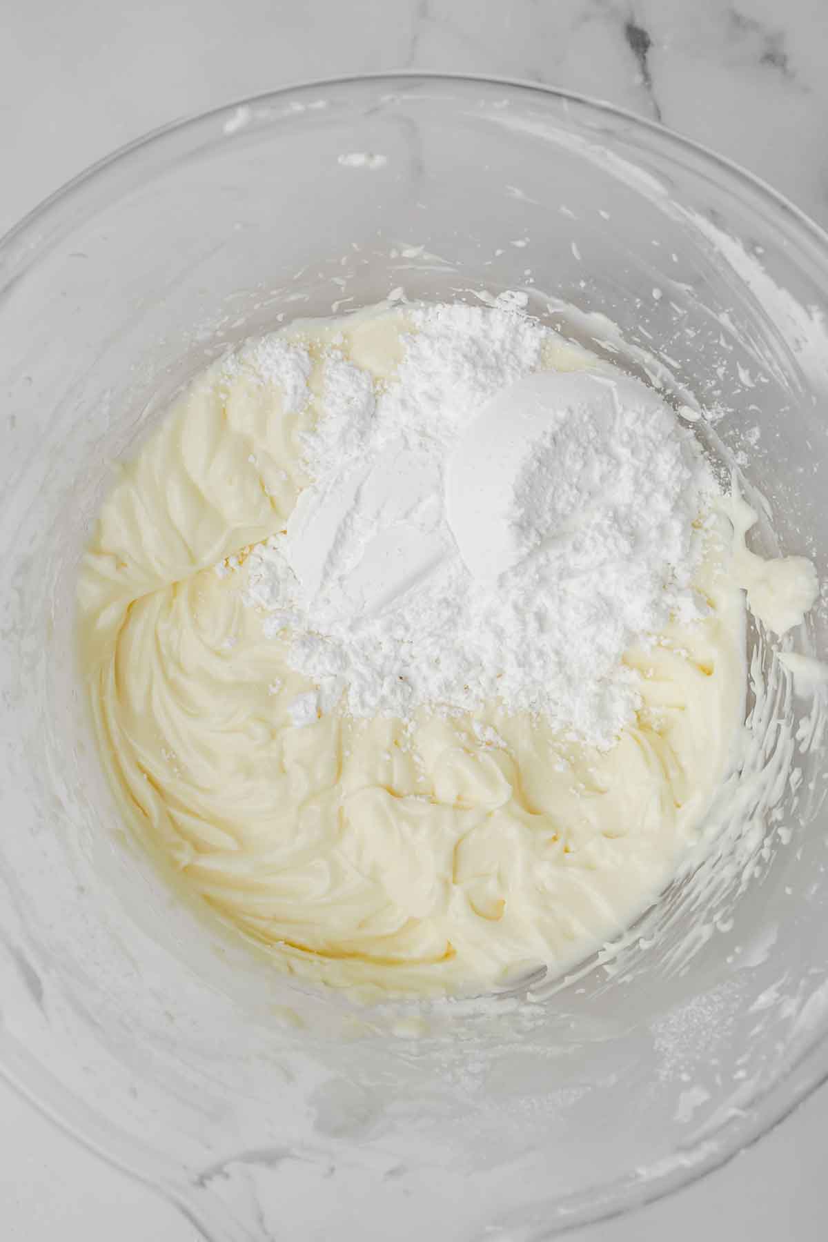 mixing bowl with cream cheese and sugar mixture