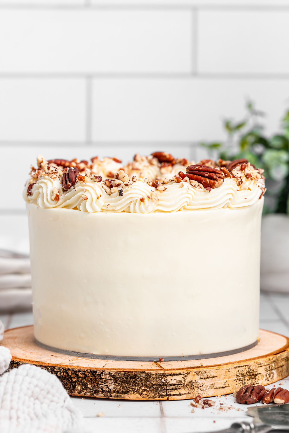 Carrot cake on a table covered with smooth cream cheese frosting