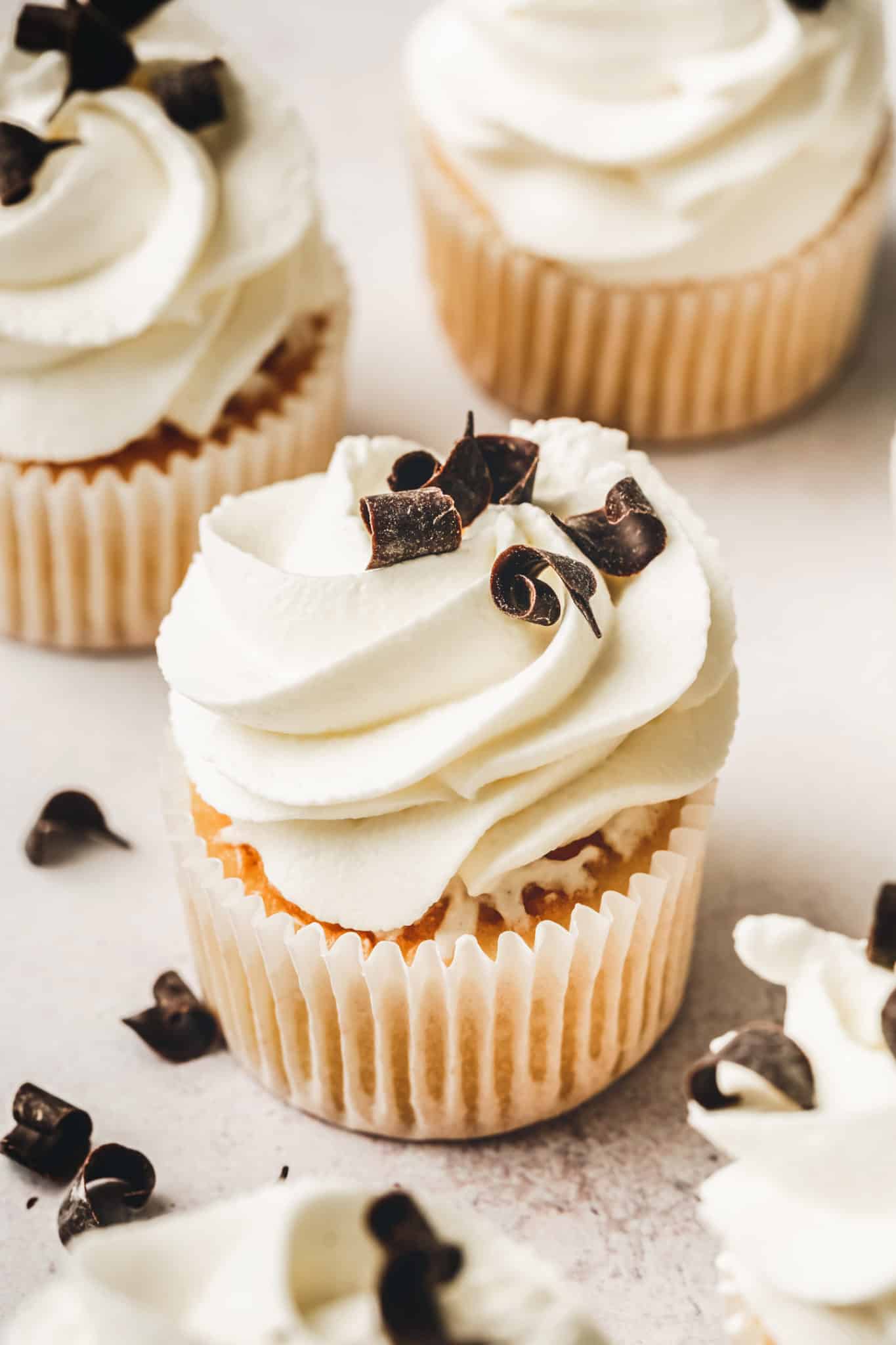 Cupcakes topped with mascarpone frosting on a table