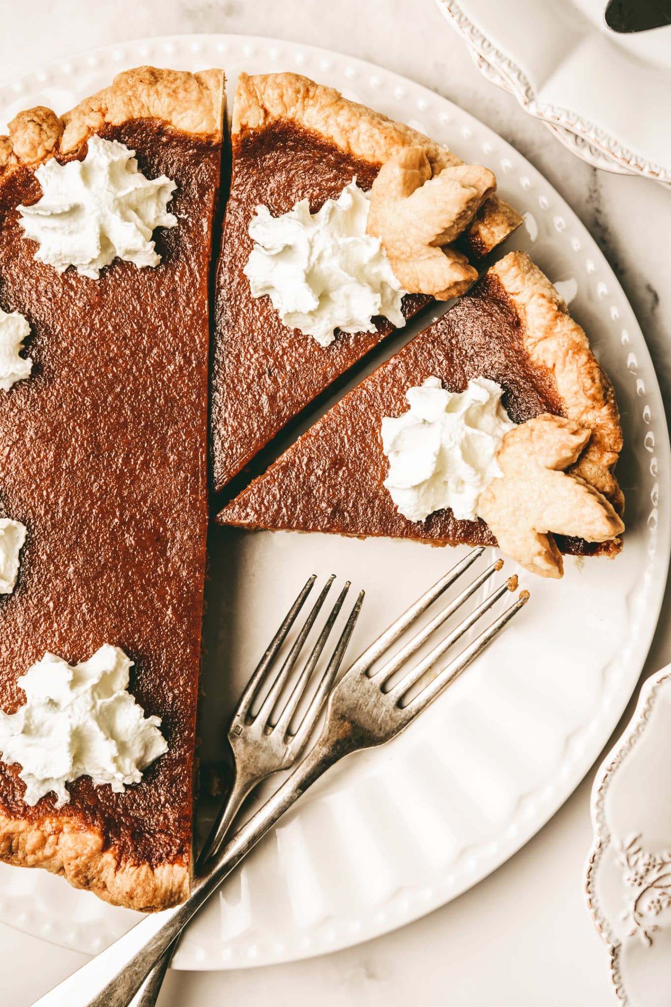 Pumpkin pie cut on a large plate