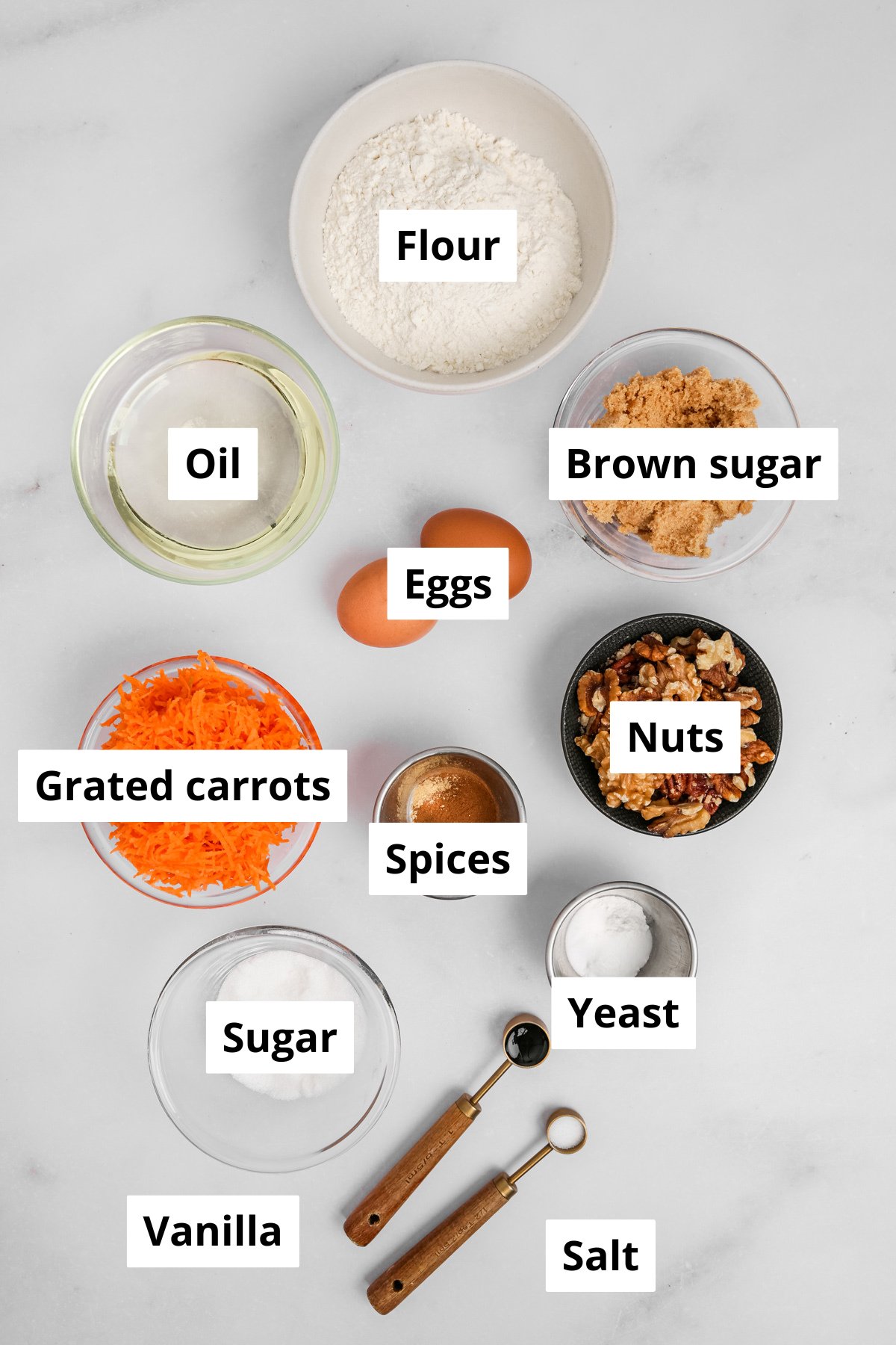 Carrot cake cupcakes ingredients bowls with flour, sugar, eggs, and grated carrots