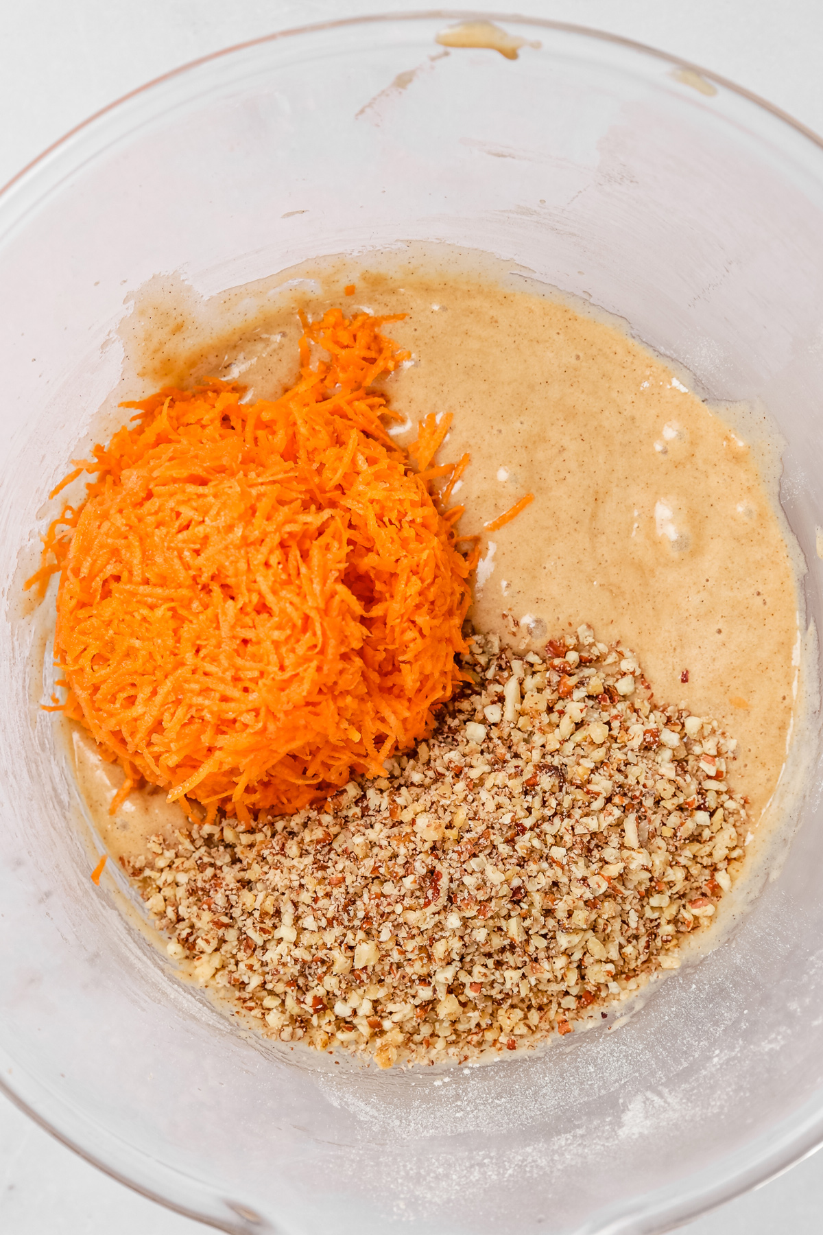 Carrot cake cupcakes batter with grated carrots and chopped nuts