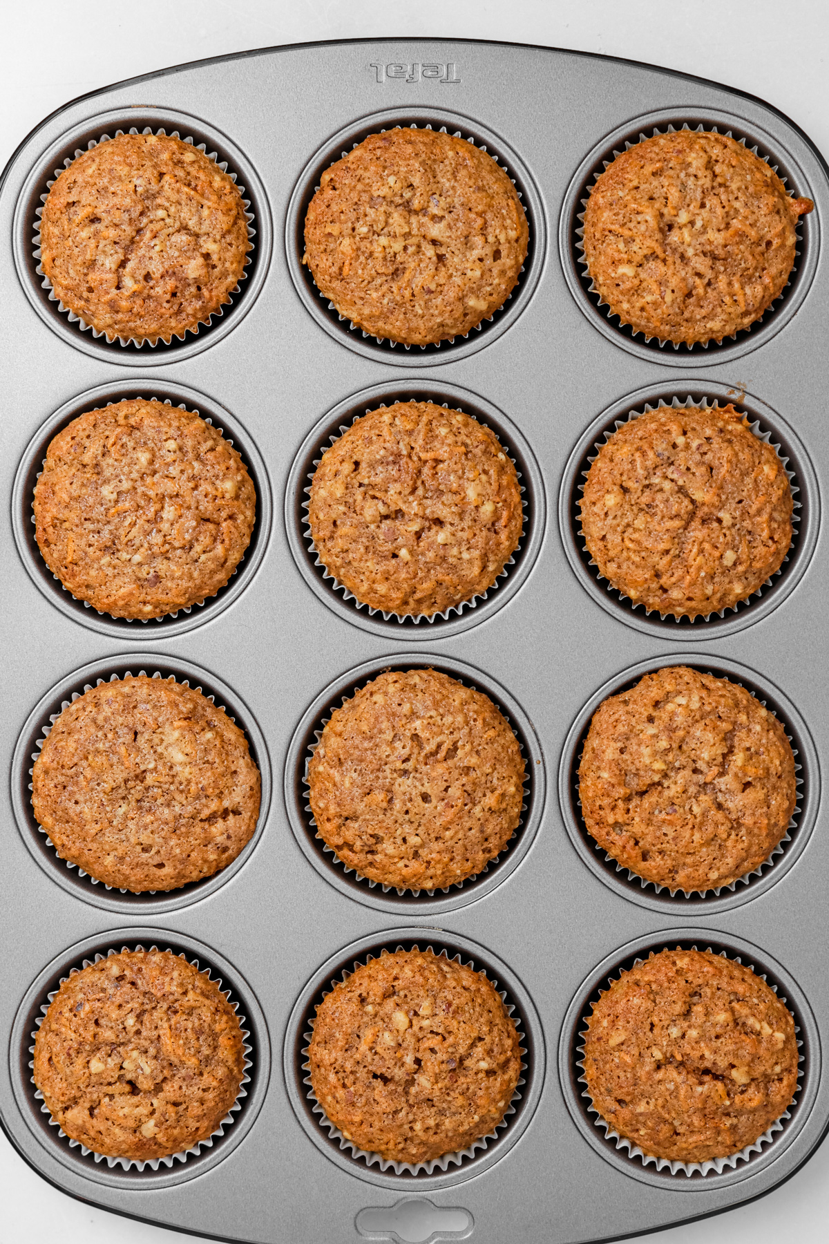 Freshly baked carrot cake cupcakes in a muffin tin