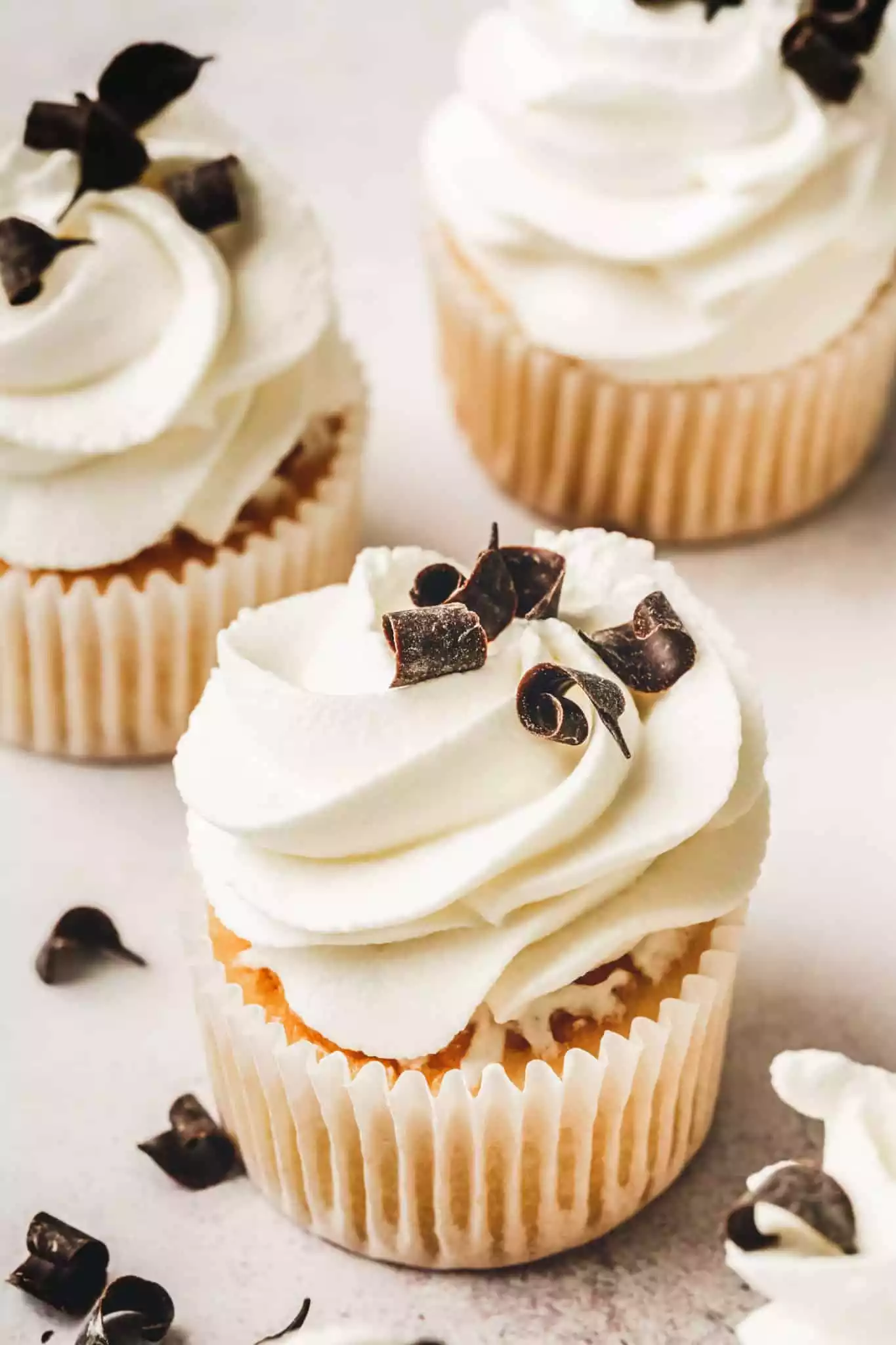 Cupcakes with mascarpone whipped cream and chocolate curls on top