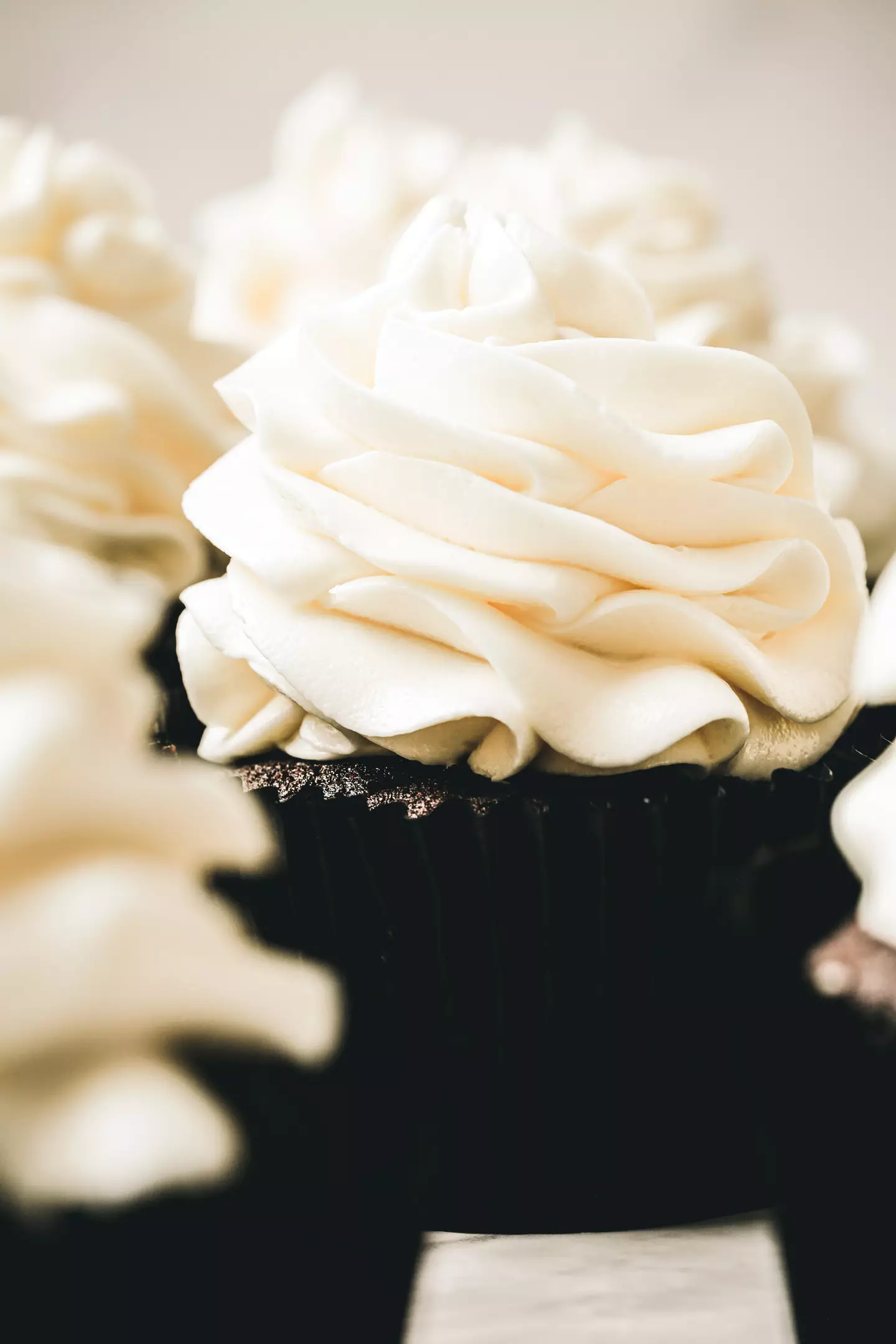 cupcakes topped with white chocolate swiss meringue buttercream