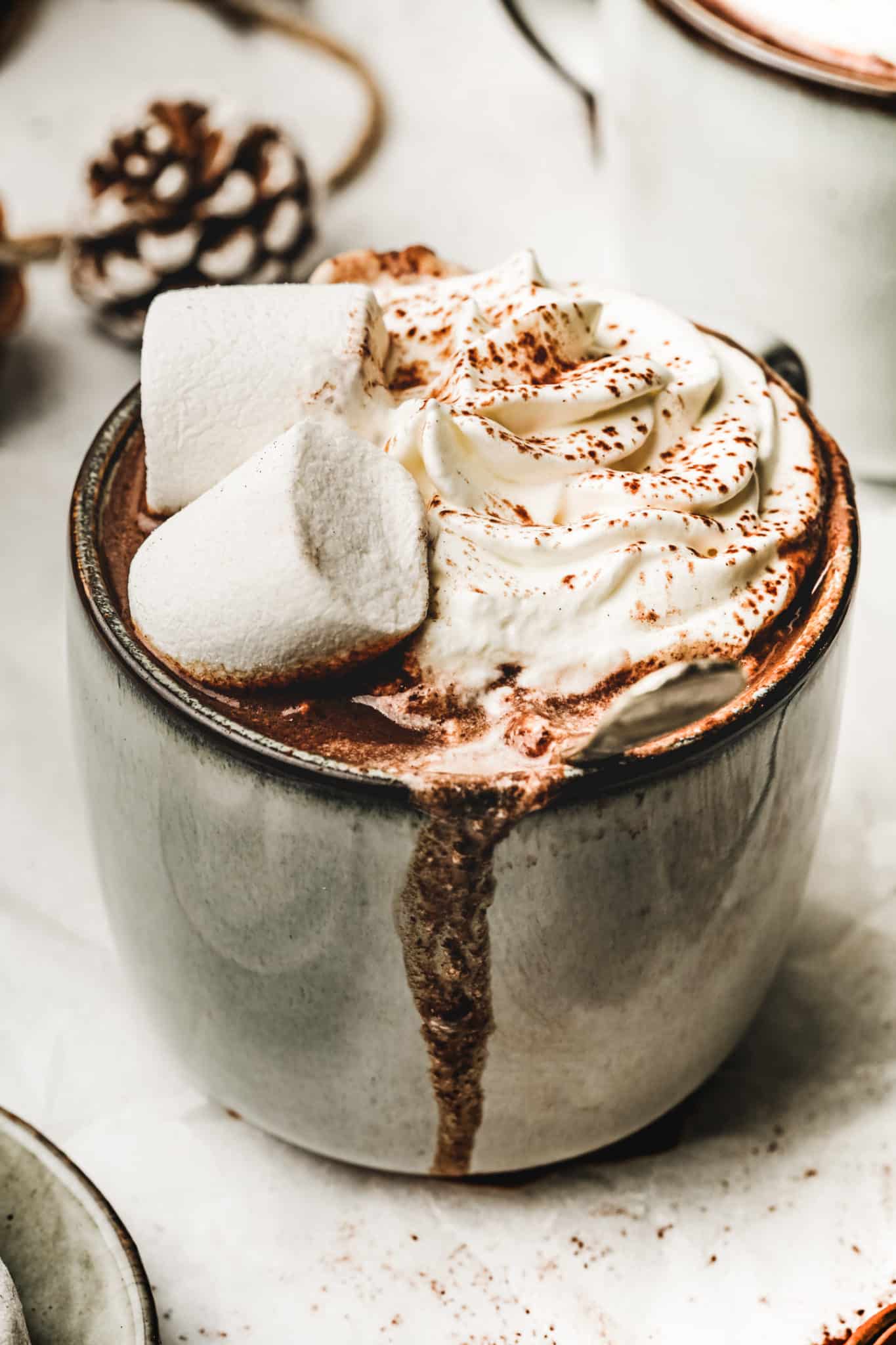 Hot chocolate drink mug with whipped cream and marshmallows