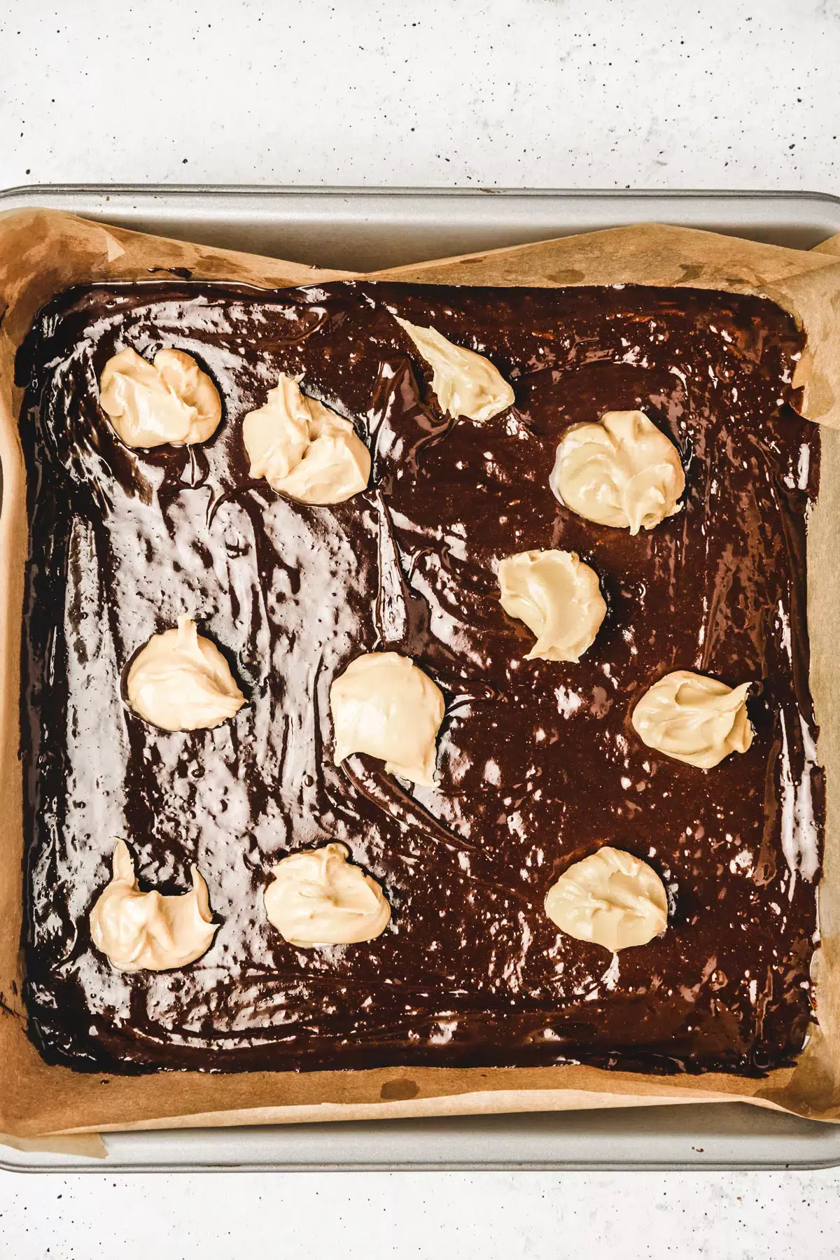 Brownie batter on a square pan
