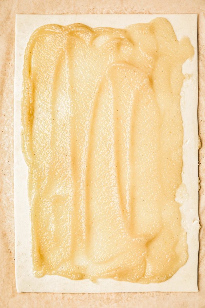 Puff pastry sheet topped with applesauce