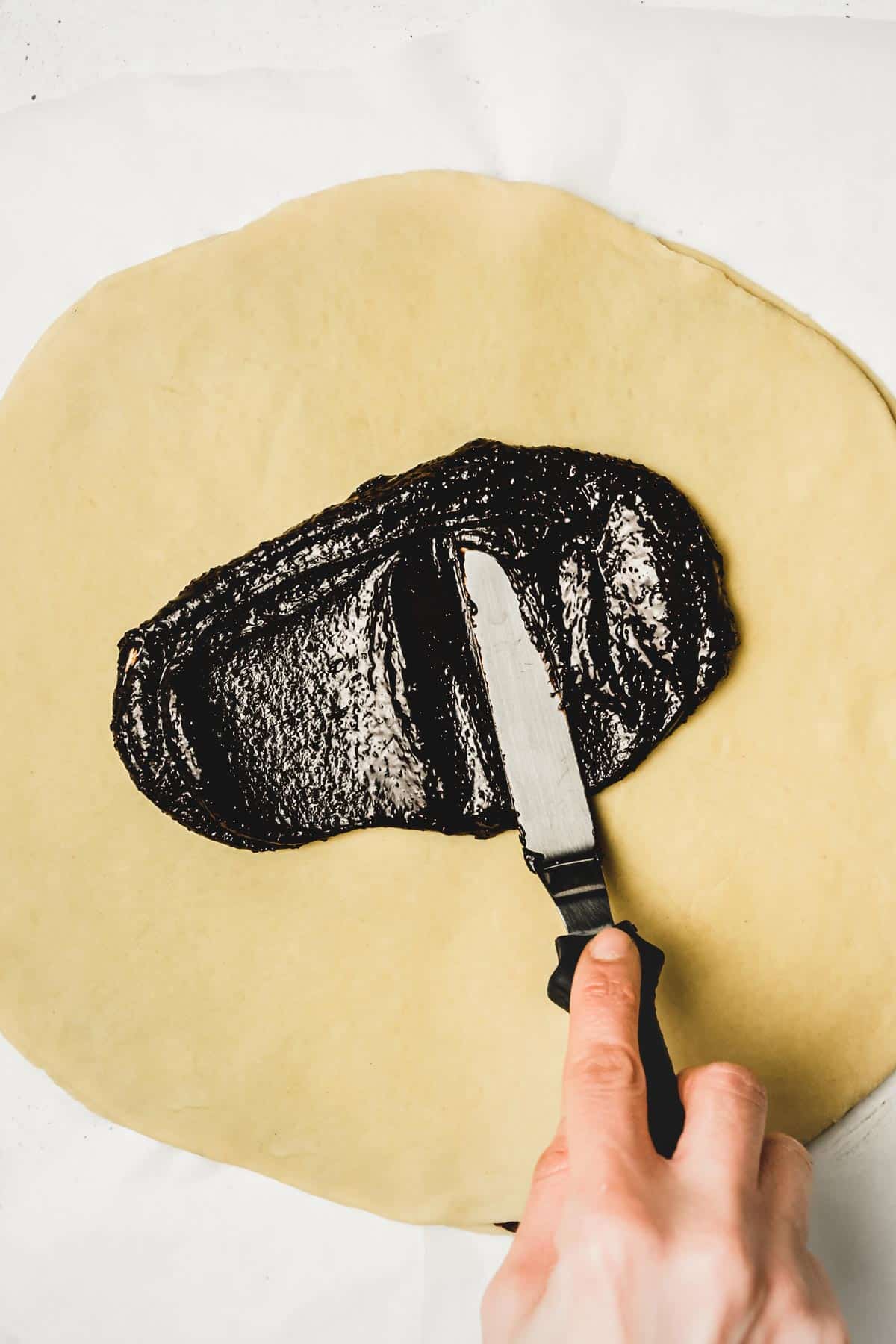 spread out layer of dough with spreaded chocolate mixture
