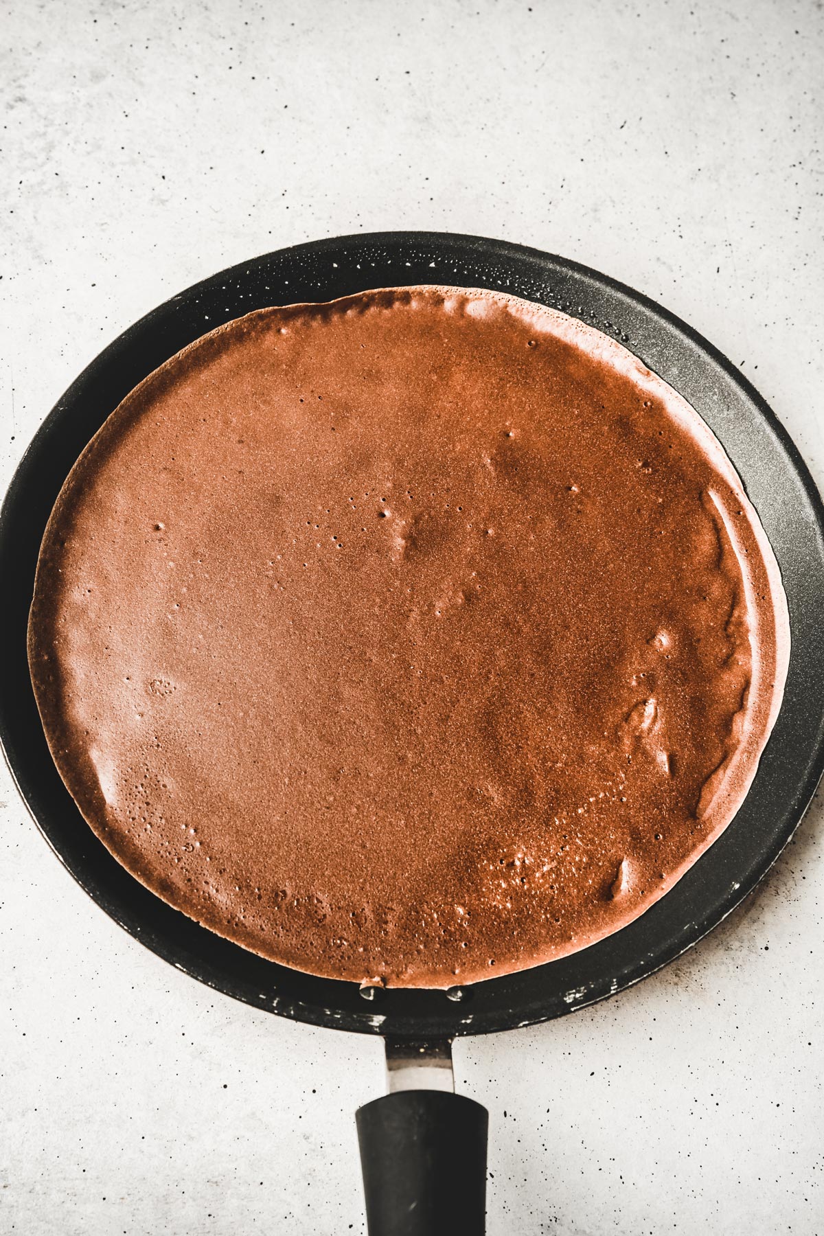 Crepe pan with a baked chocolate crepe