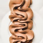 Chocolate mascarpone frosting pipped on a plate