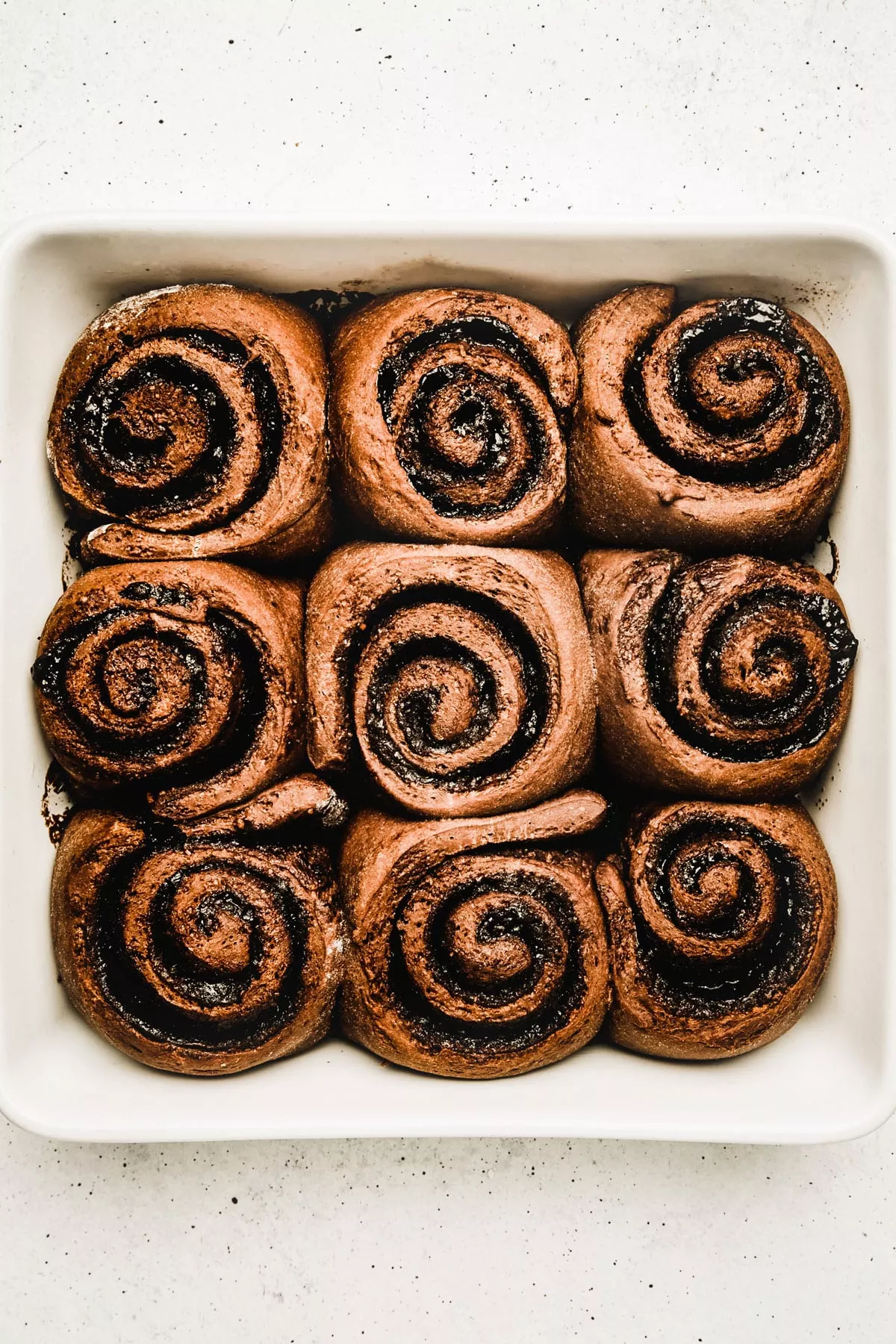 Freshly baked chocolate cinnamon rolls in a baking dish