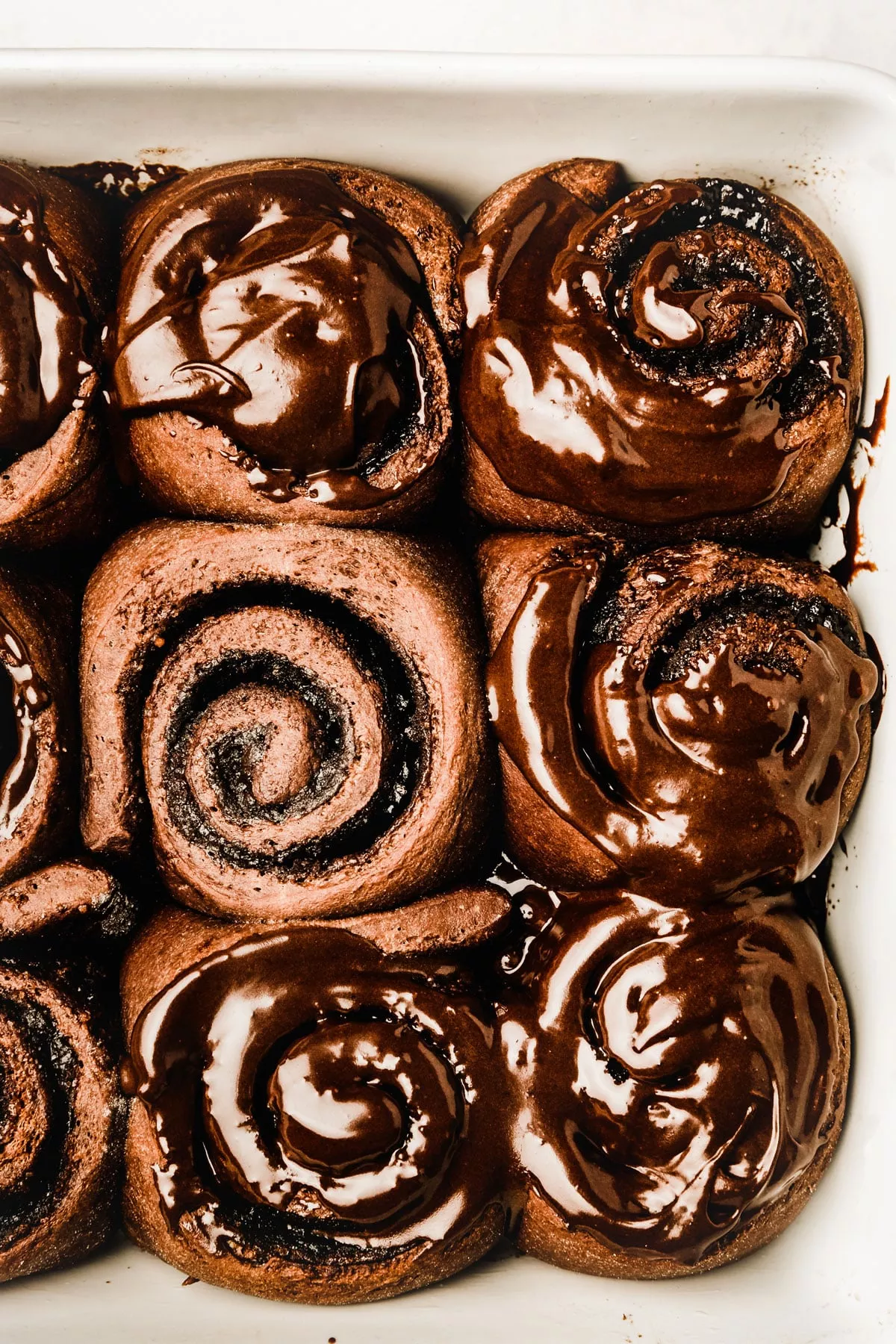 Chocolate cinnamon rolls served with chocolate glaze